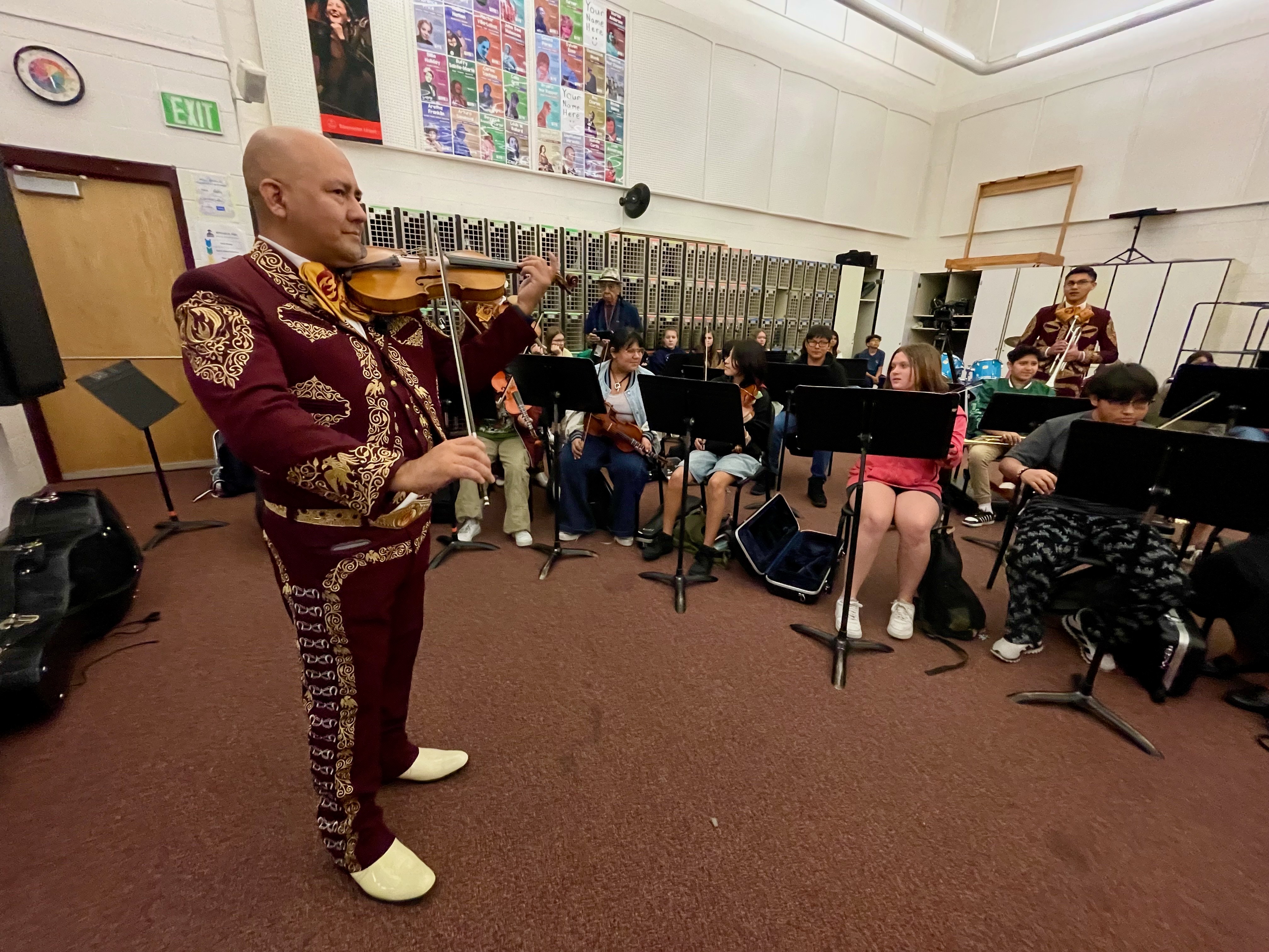 Marx Huancas, left, director of Mariachi Fuego de Utah, at a gathering of his youth ensemble and the mariachi class at Jefferson Junior High School in Kearns on Wednesday.