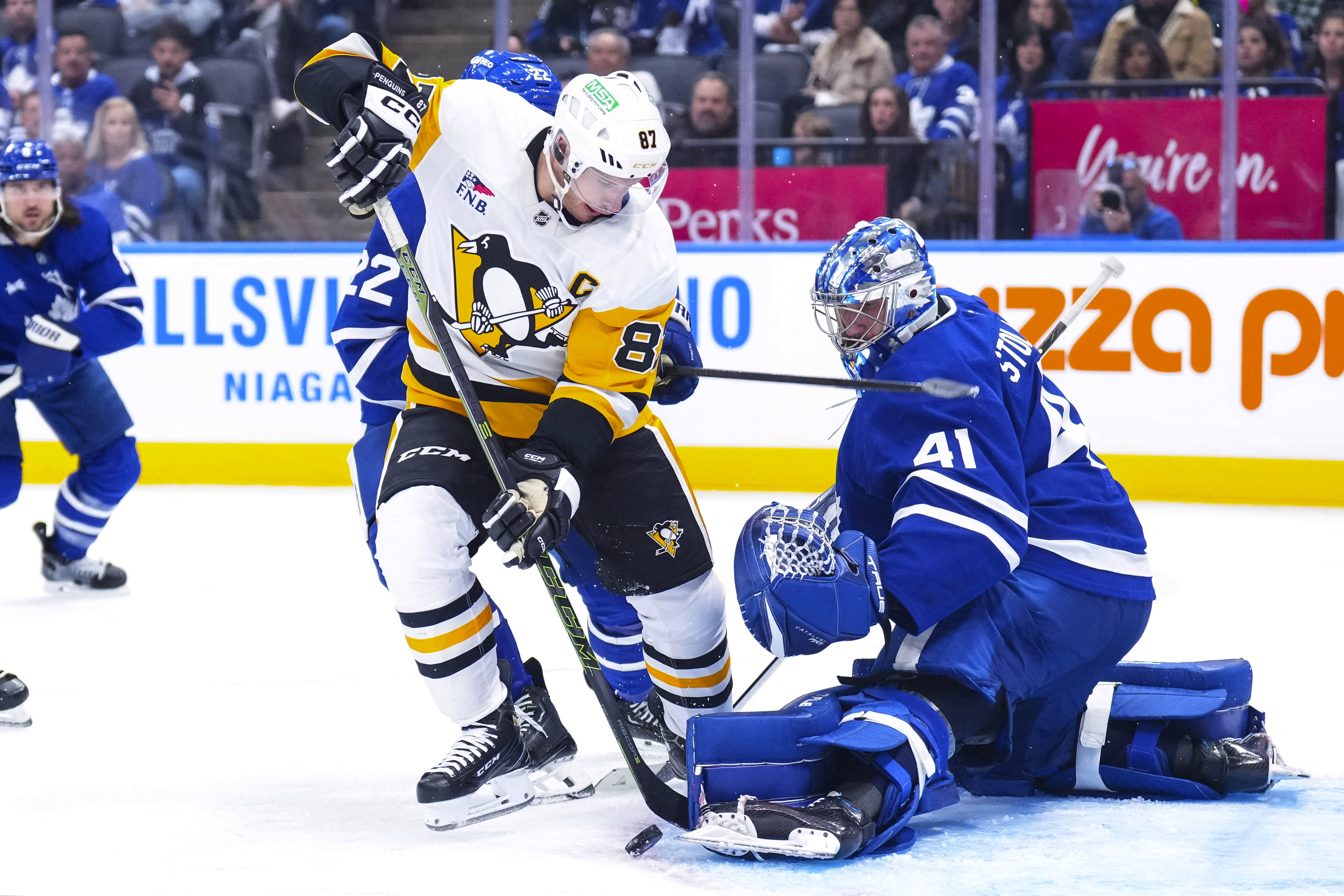 Toronto Maple Leafs goaltender Anthony Stolarz, right, saves a shot by Pittsburgh Penguins' Sidney Crosby (87) during third-period NHL hockey game action in Toronto, Saturday, Oct. 12, 2024. 