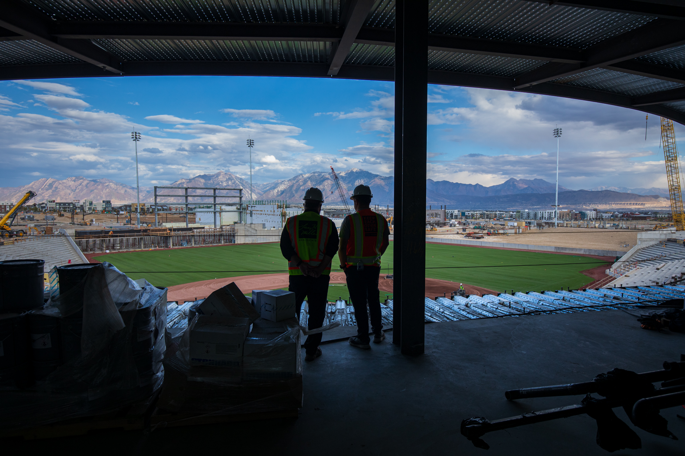 Larry H. Miller executives take in the view from the top level of Daybreak Field during a tour of the stadium on Wednesday. The field's playing surface was completed this week.