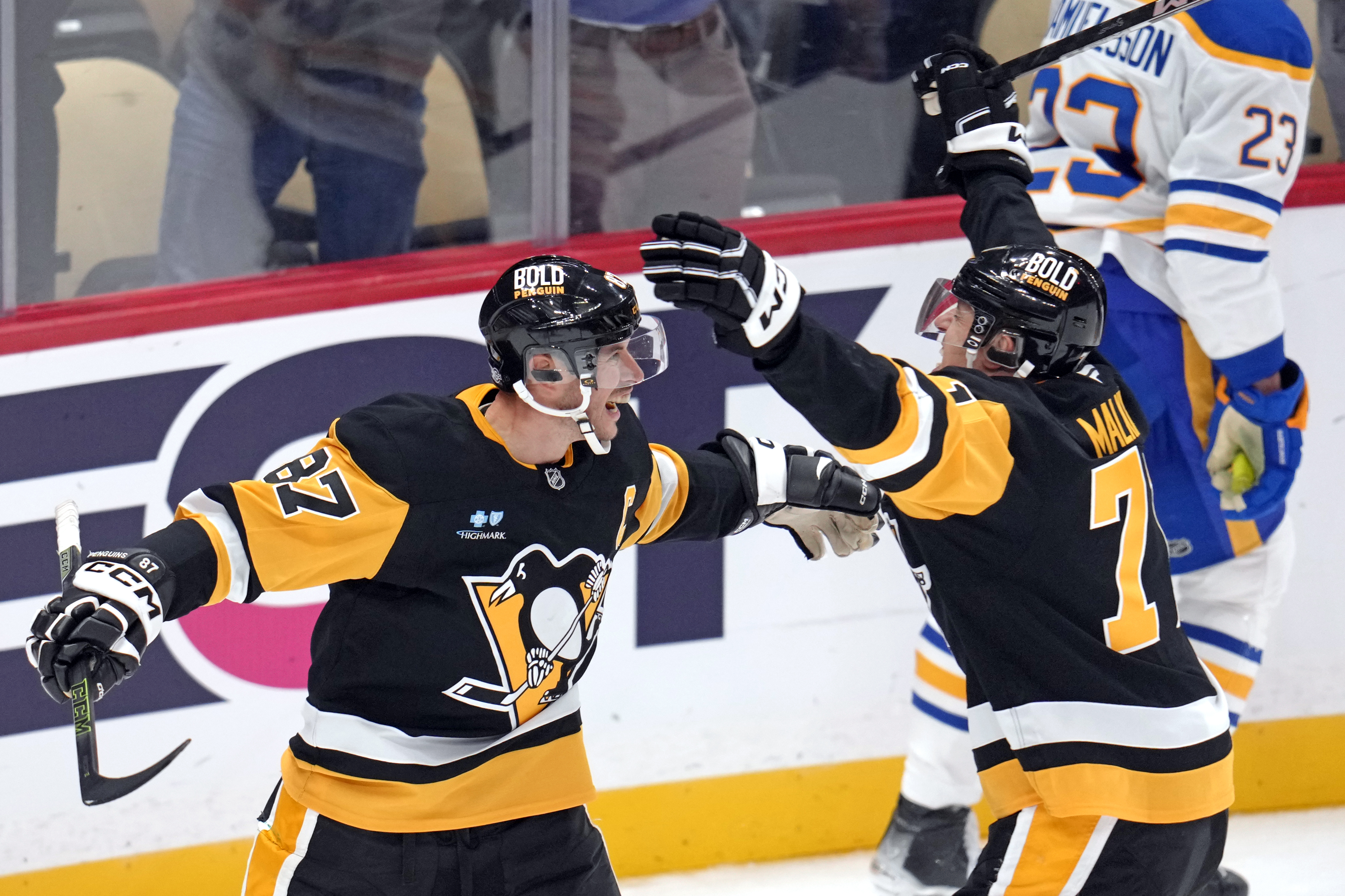 Pittsburgh Penguins' Sidney Crosby (87) celebrates his game-winning goal in overtime with Evgeni Malkin during an NHL hockey game against the Buffalo Sabres in Pittsburgh, Wednesday, Oct. 16, 2024. 