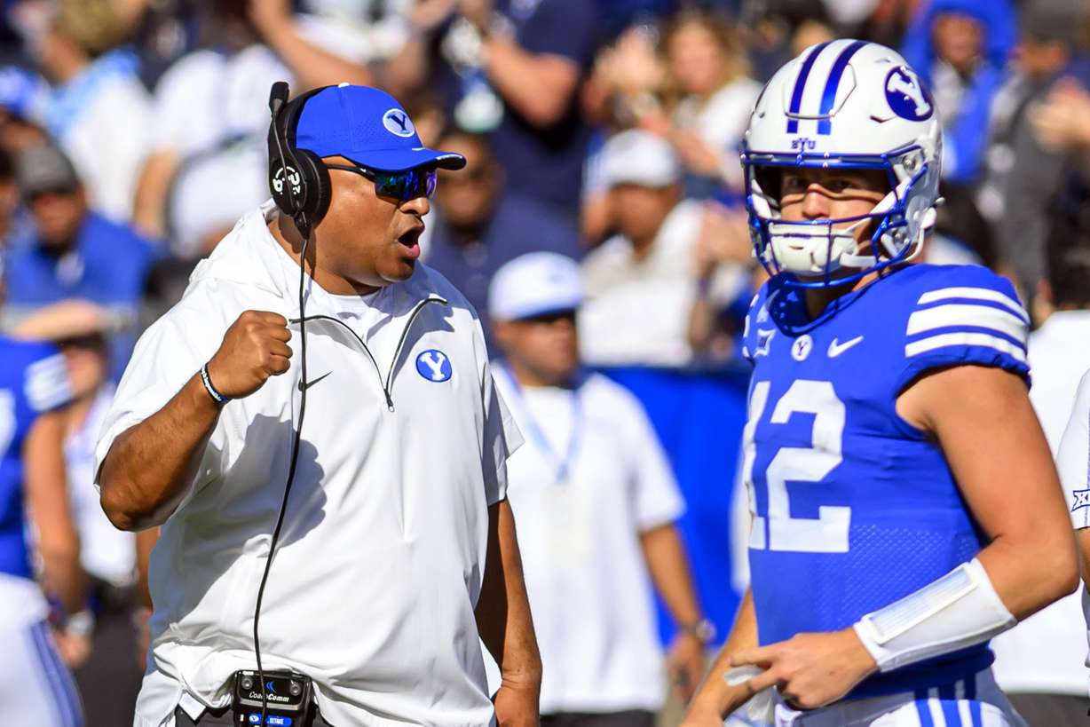 BYU head coach Kalani Sitake, left, celebrates an overturned play call after review during an NCAA college football game against Arizona, Saturday, Oct. 12, 2024, in Provo, Utah.