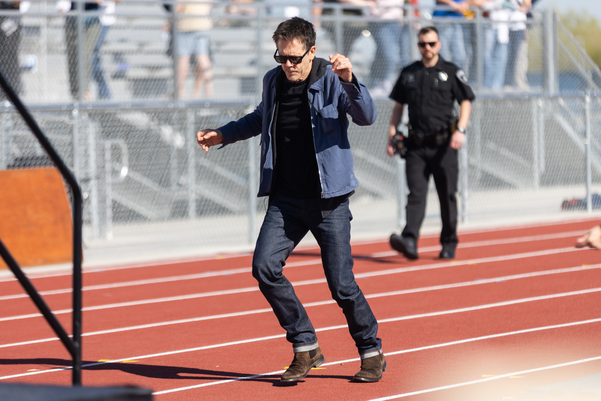 Kevin Bacon dances his way to the stage at Payson High School before partaking in a community kit-building program with Bacon’s charity Six Degrees in Payson on April 20.
