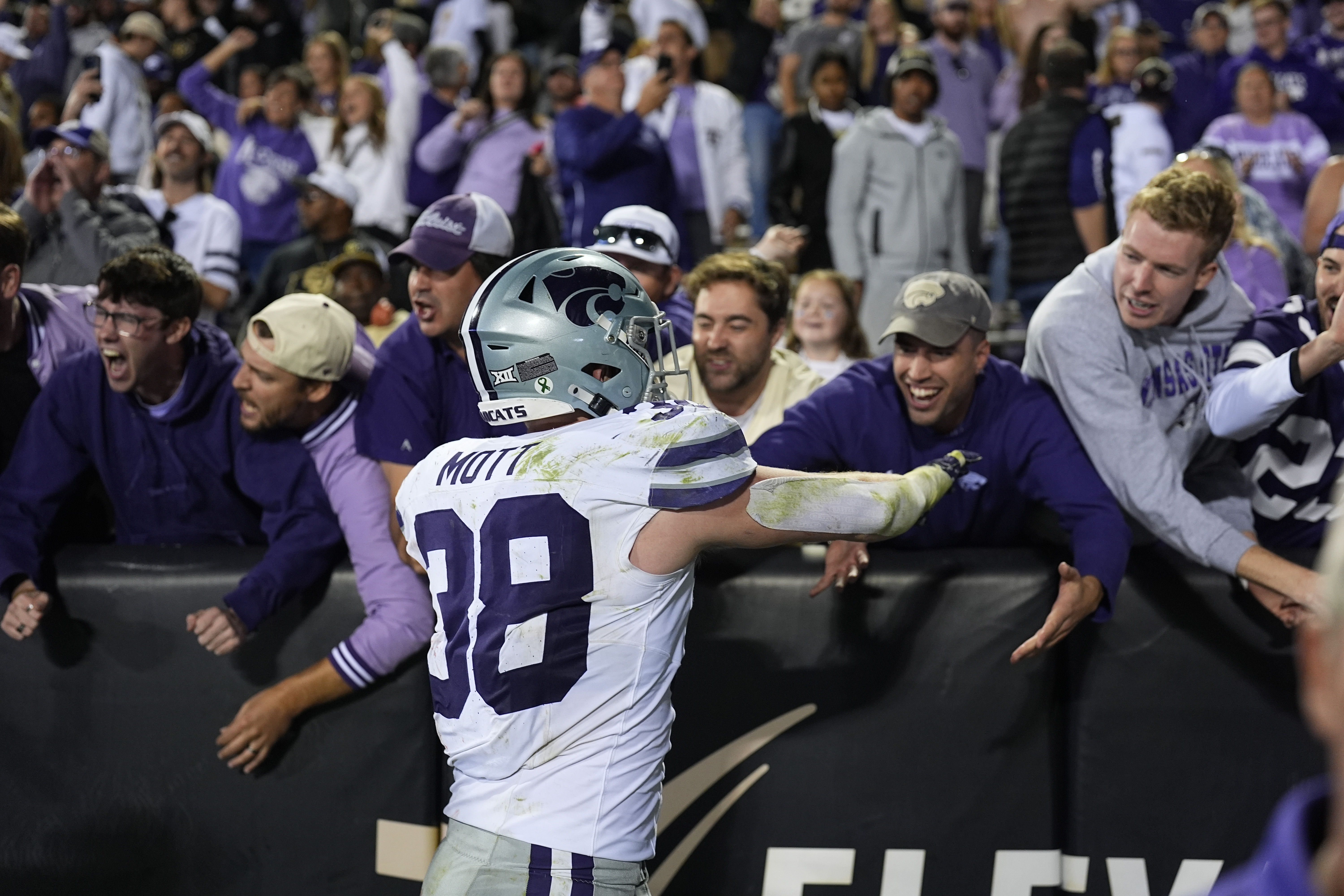 Kansas State defensive end Brendan Mott is congratulated by fans after an NCAA college football game against Colorado Saturday, Oct. 12, 2024, in Boulder, Colo. 
