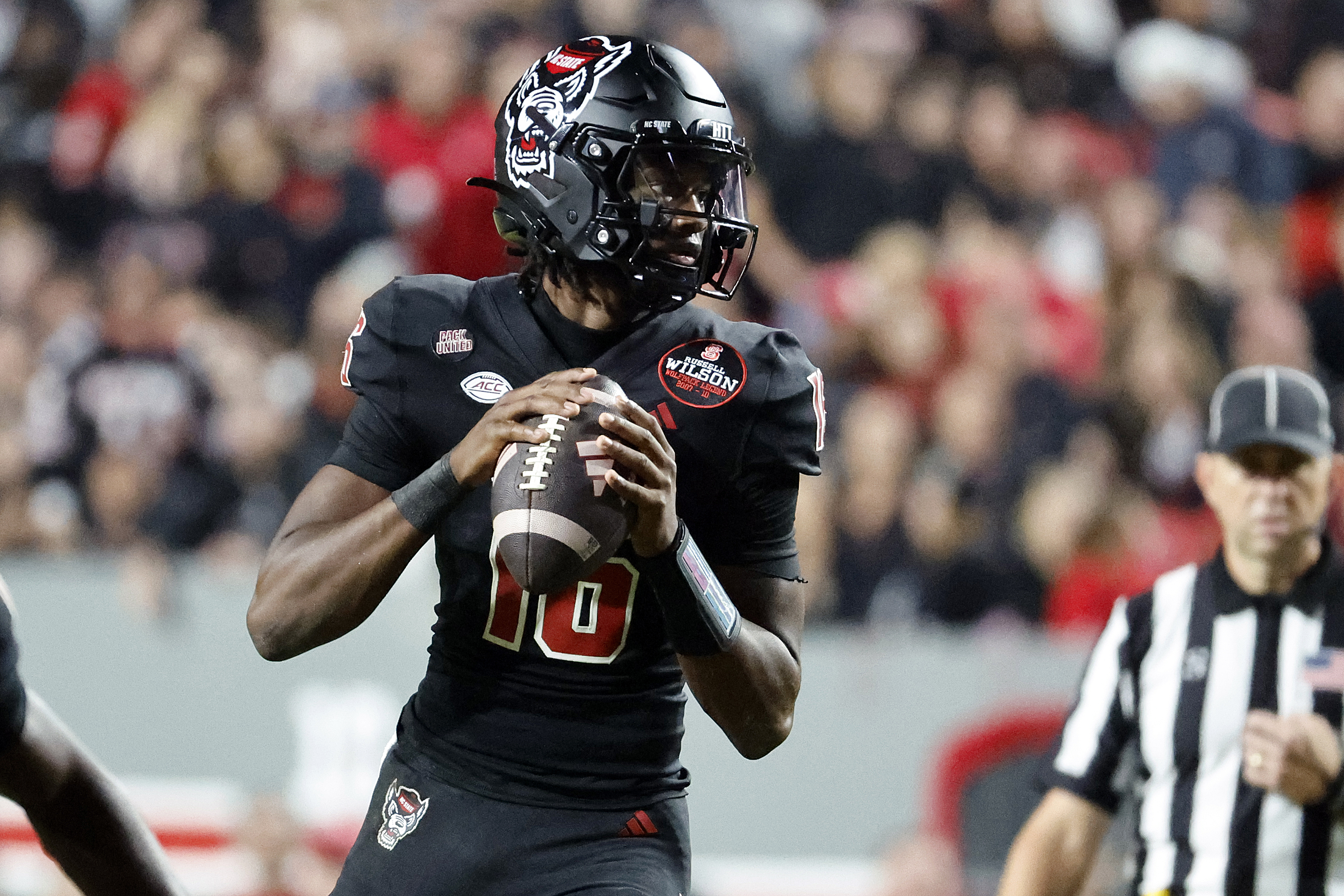 North Carolina State quarterback CJ Bailey (16) looks to pass the ball against Syracuse during the second half of an NCAA college football game in Raleigh, N.C., Saturday, Oct. 12, 2024.