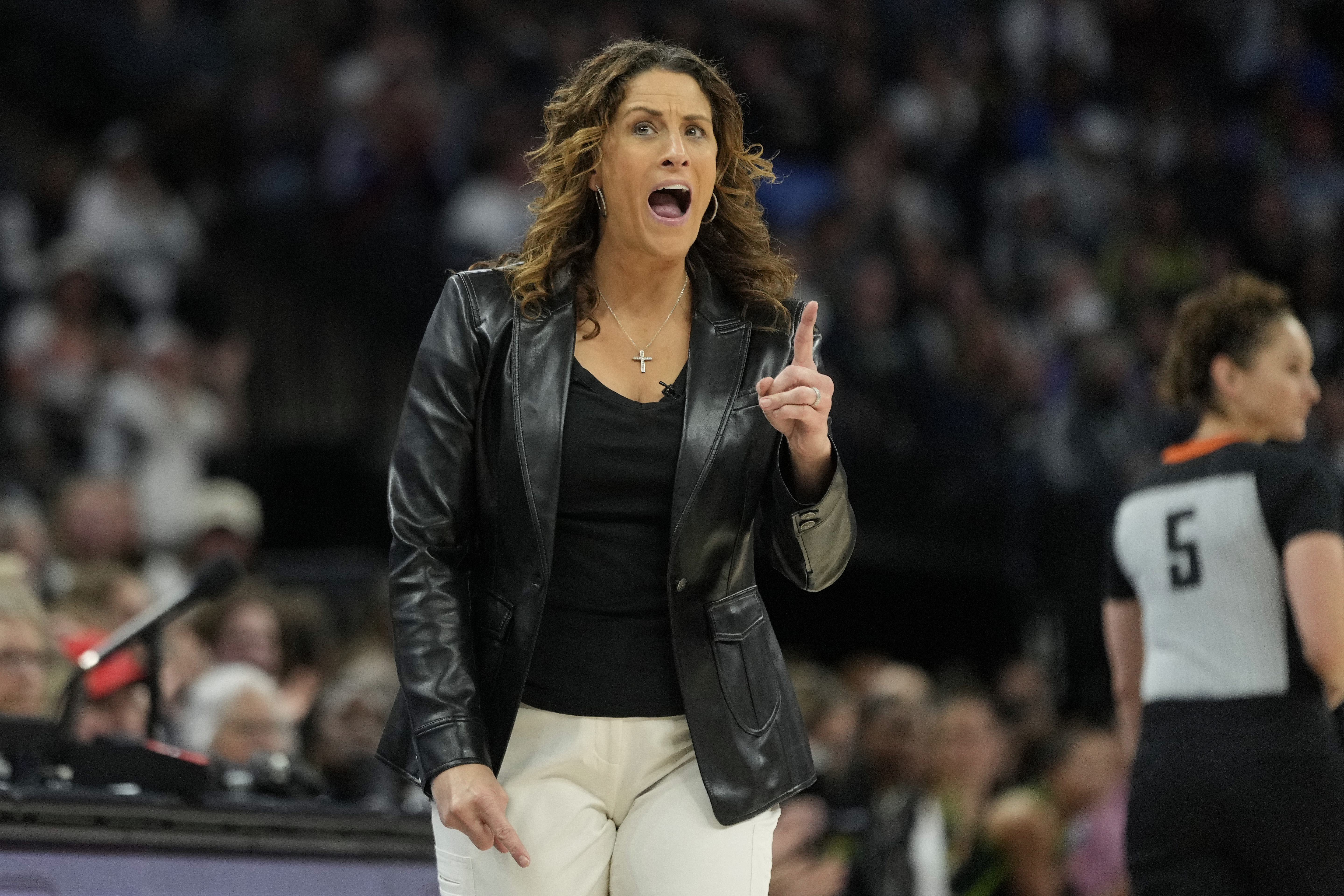 Connecticut Sun head coach Stephanie White reacts after a foul called on the Sun during the first half of Game 5 of a WNBA basketball semifinals against the Minnesota Lynx, Tuesday, Oct. 8, 2024, in Minneapolis.
