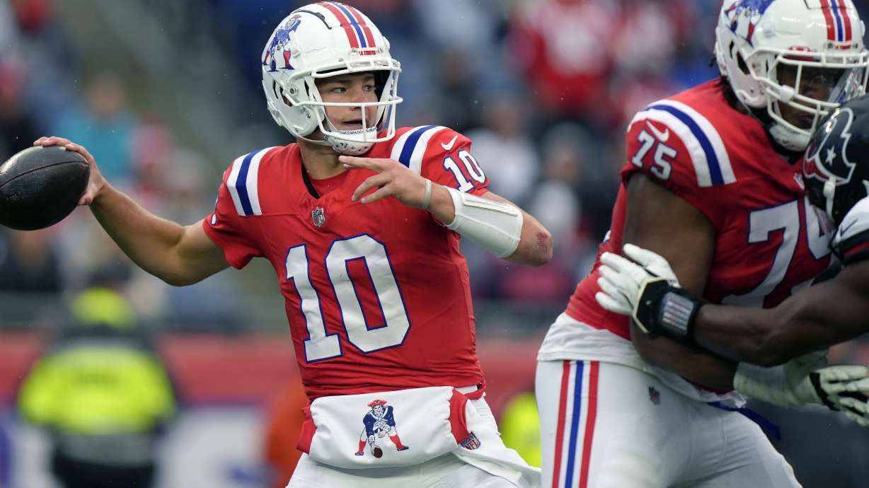 New England Patriots quarterback Drake Maye (10) looks to pass the ball as offensive tackle Demontrey Jacobs (75) defends during the second half of an NFL football game against the Houston Texans, Sunday, Oct. 13, 2024, in Foxborough, Mass.