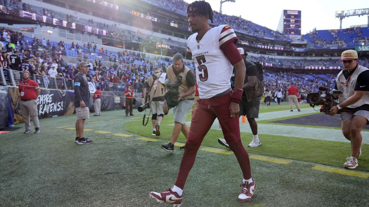 Washington Commanders quarterback Jayden Daniels walks off the field following an NFL football game against the Baltimore Ravens Sunday, Oct. 13, 2024, in Baltimore. The Ravens won 30-23.