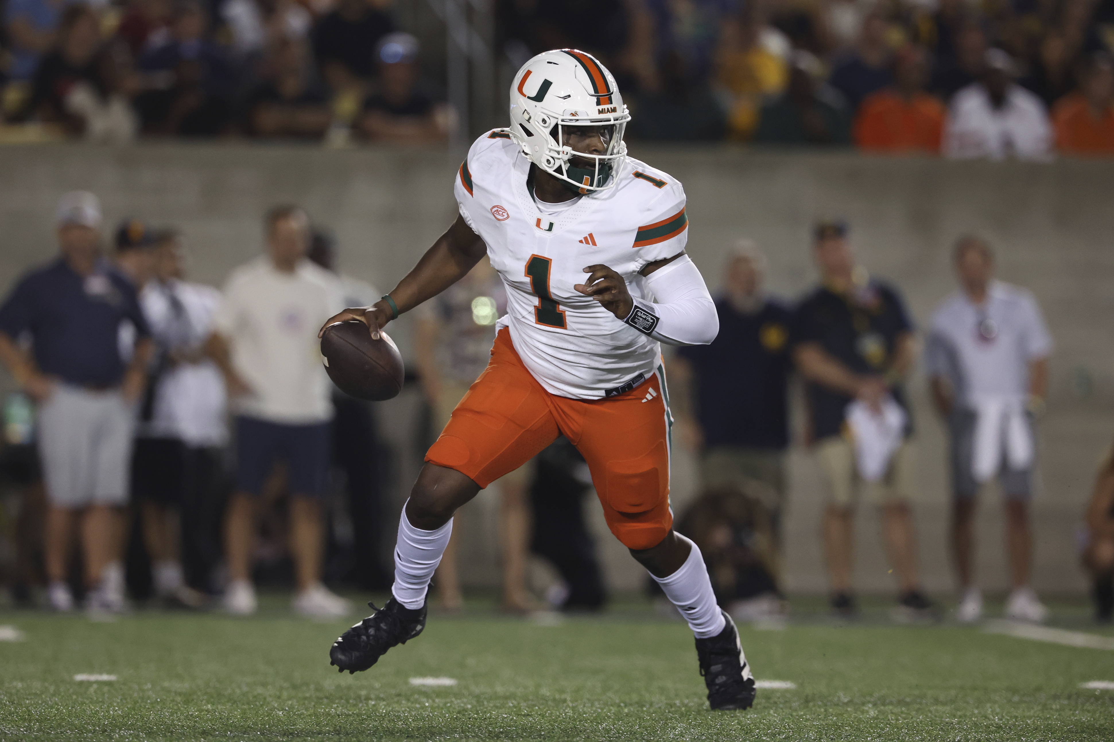 Miami quarterback Cam Ward (1) runs against California during the first half of an NCAA college football game in Berkeley, Calif., Saturday, Oct. 5, 2024. 
