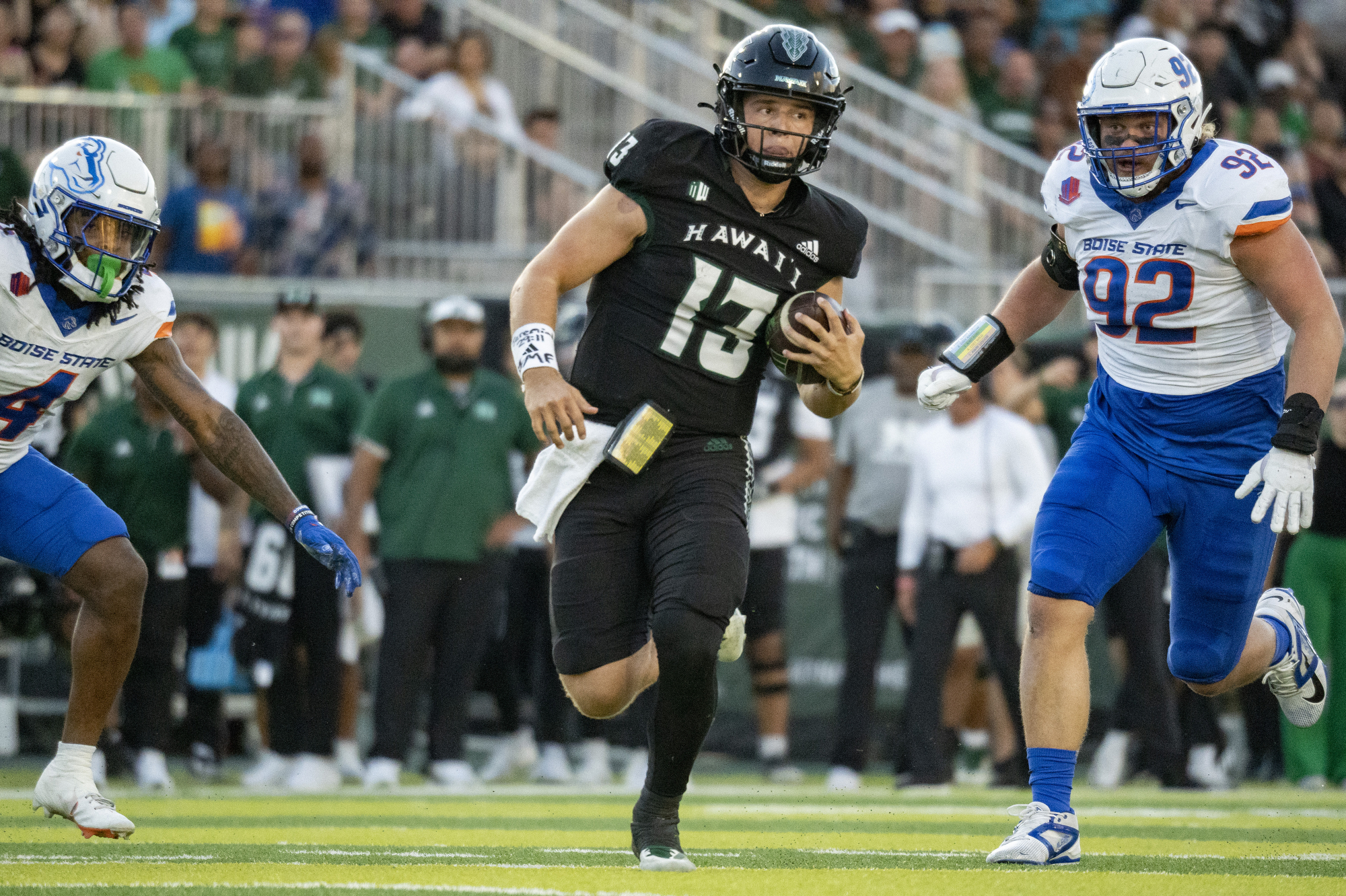 Hawaii quarterback Brayden Schager (13) runs the ball during the first half of an NCAA college football game against Boise State, Saturday, Oct. 12, 2024, in Honolulu. 