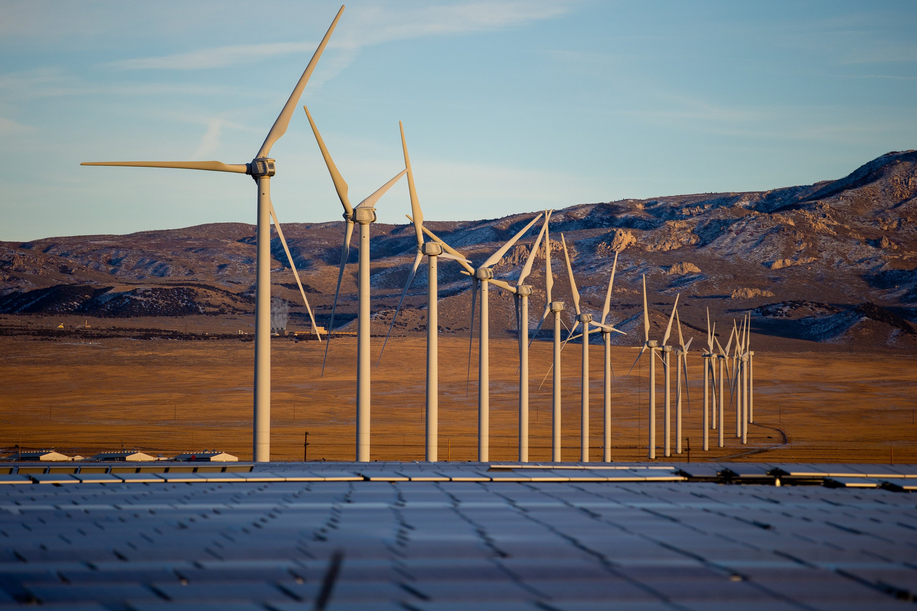 Wind turbines that are part of the Milford Wind Corridor Project tower over photovoltaic solar panels, foreground, north of Milford, Beaver County, on Jan. 15, 2021. Many people are paying too much for their energy bills.