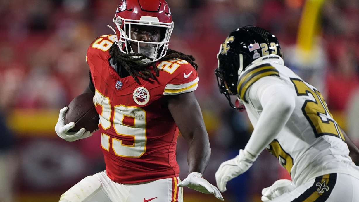 Kansas City Chiefs running back Kareem Hunt (29) runs with the ball as New Orleans Saints cornerback Paulson Adebo (29) defends during the first half of an NFL football game Monday, Oct. 7, 2024, in Kansas City, Mo.