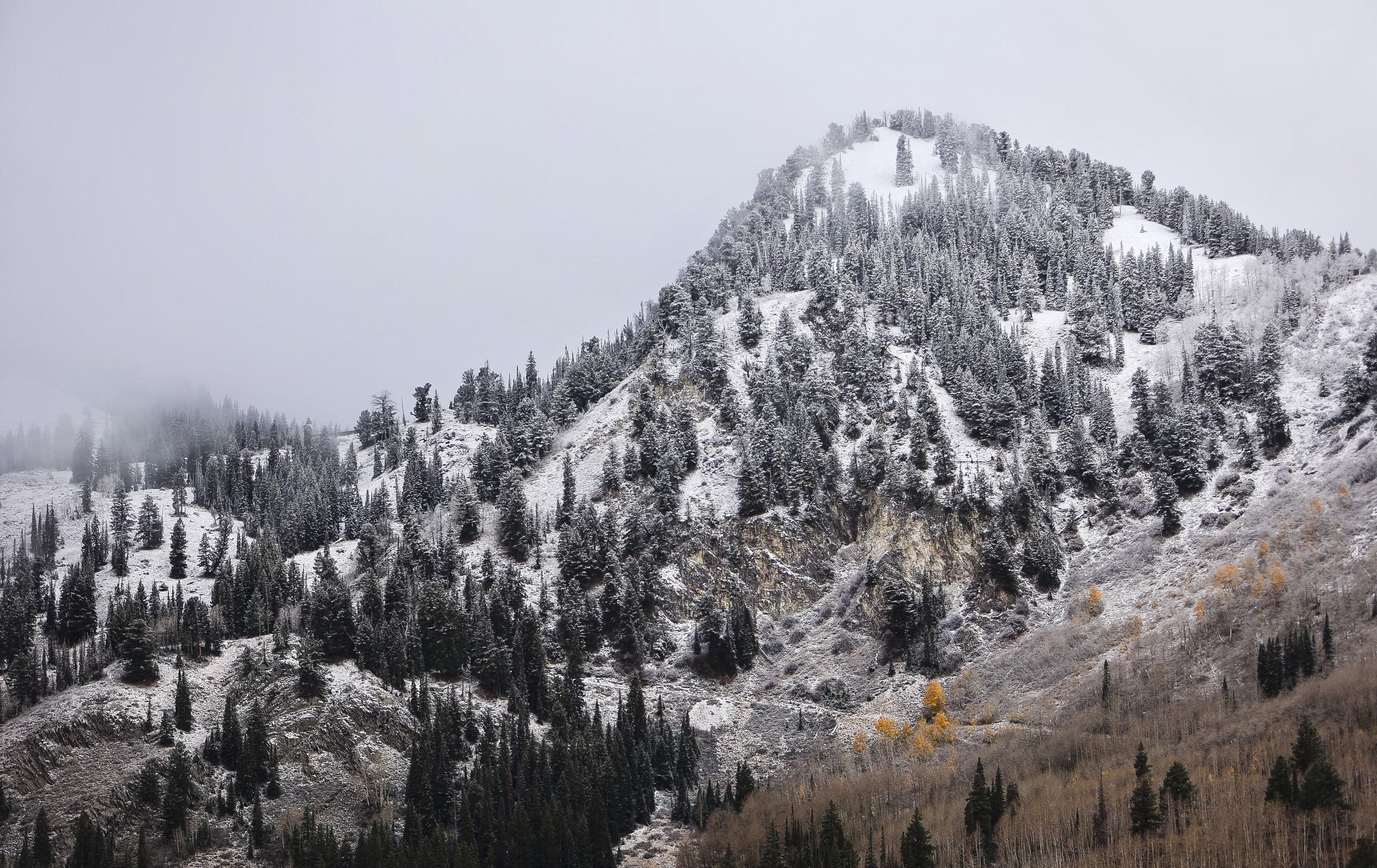 A thin dusting of snow covers part of the mountainside in Big Cottonwood Canyon on Thursday. Utah Department of Transportation officials unveiled their plans on Thursday to increase law enforcement at traction checkpoints, while Salt Lake County eyes future traction changes. 