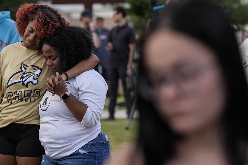 Mourners pray during a candlelight vigil for the slain students and teachers at Apalachee High School, Sept. 4 in Winder, Ga.