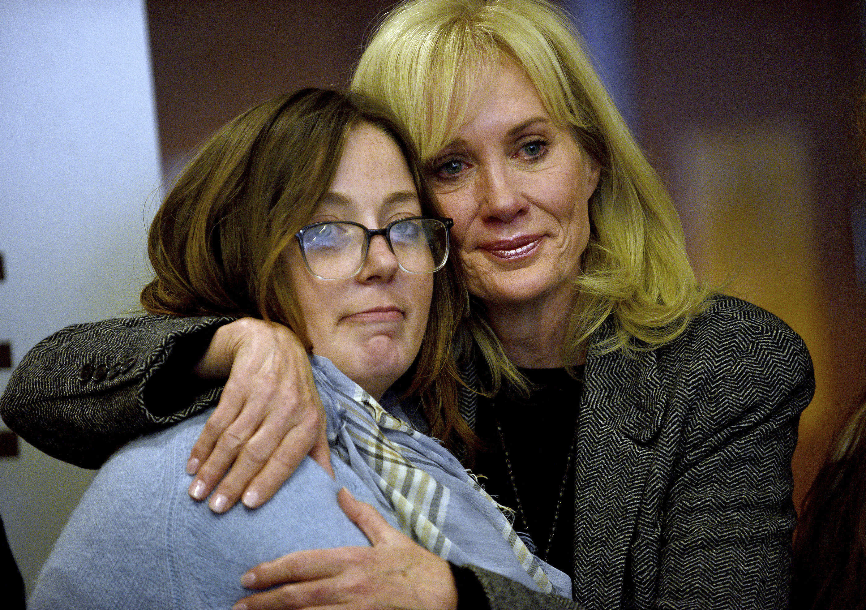 Alexandra Eckersley, who was convicted on charges that she abandoned her newborn in the woods, hugs her mother, Nancy Eckersley, after her sentence was suspended at a hearing at Hillsborough County Superior Court in Manchester, N.H., on Thursday, Oct. 17, 2024. 