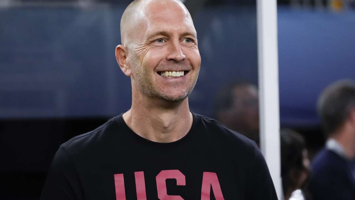 FILE - United States head coach Gregg Berhalter smiles from the bench before a CONCACAF Nations League final soccer match against Mexico, Sunday, March 24, 2024, in Arlington, Texas.