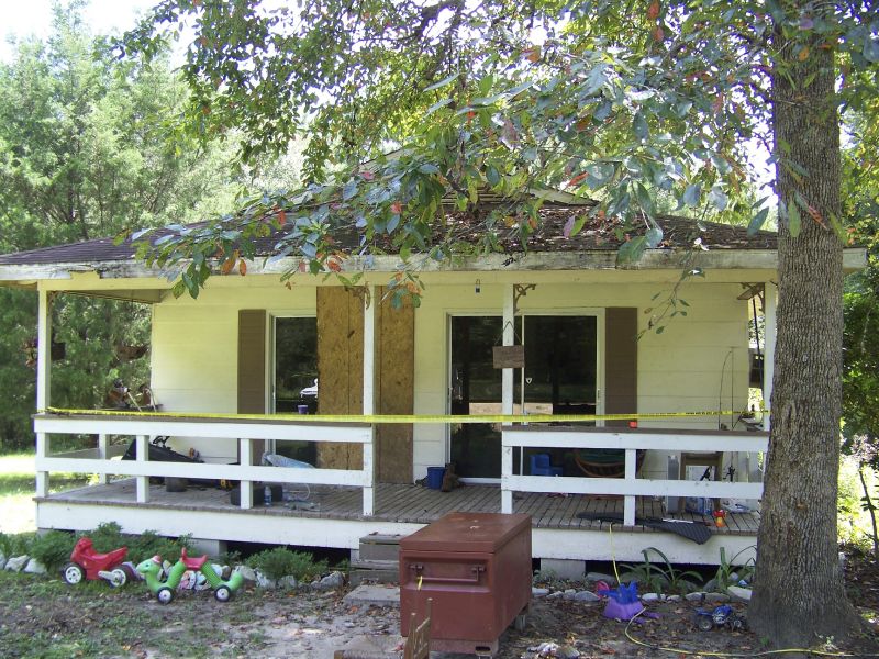 Crime scene tape marks the home on Jim Platt Road near Citronelle, Ala., Aug. 21, 2016, where authorities said five people were killed.