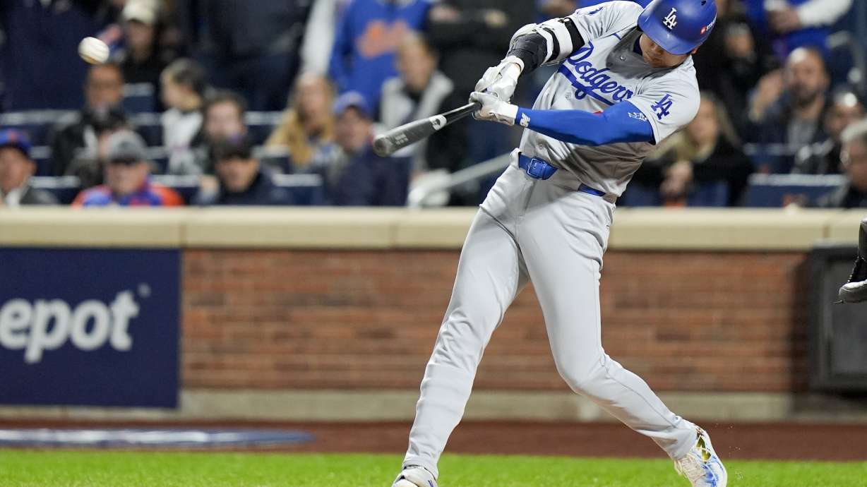 Los Angeles Dodgers' Shohei Ohtani hits a home run against the New York Mets during the first inning in Game 4 of a baseball NL Championship Series, Thursday, Oct. 17, 2024, in New York.