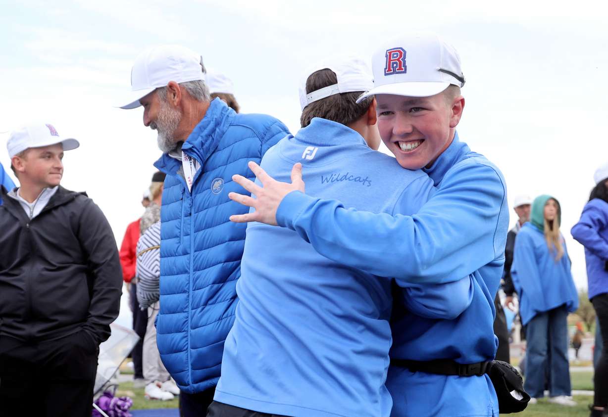 Richfield players hug after Richfield won the team category in the 3A boys golf championships at The Ridge Golf Club on West Valley City on Thursday, Oct. 17, 2024.