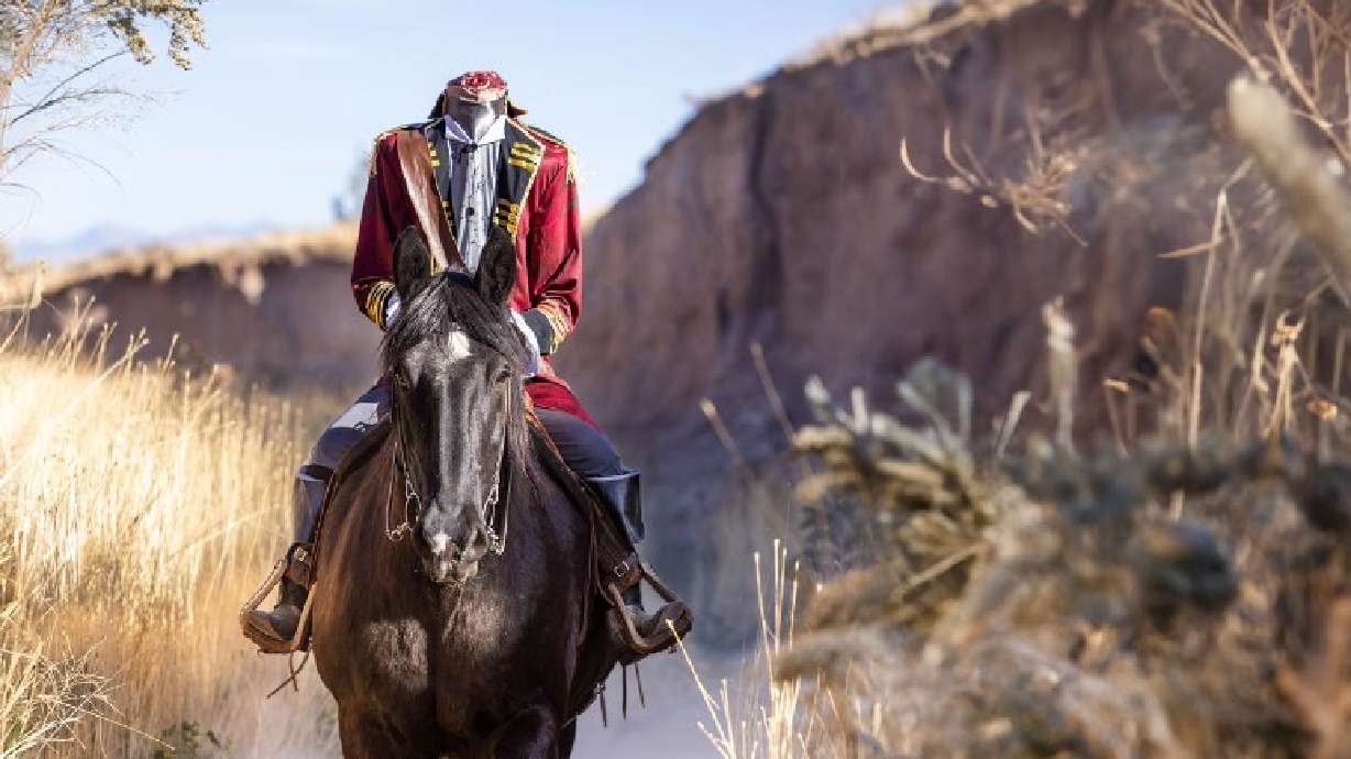 Tiffany Ulmer, of Eagle Mountain, rides around the community dressed as the Headless Horseman in an effort to bring joy to the community during the month of October.