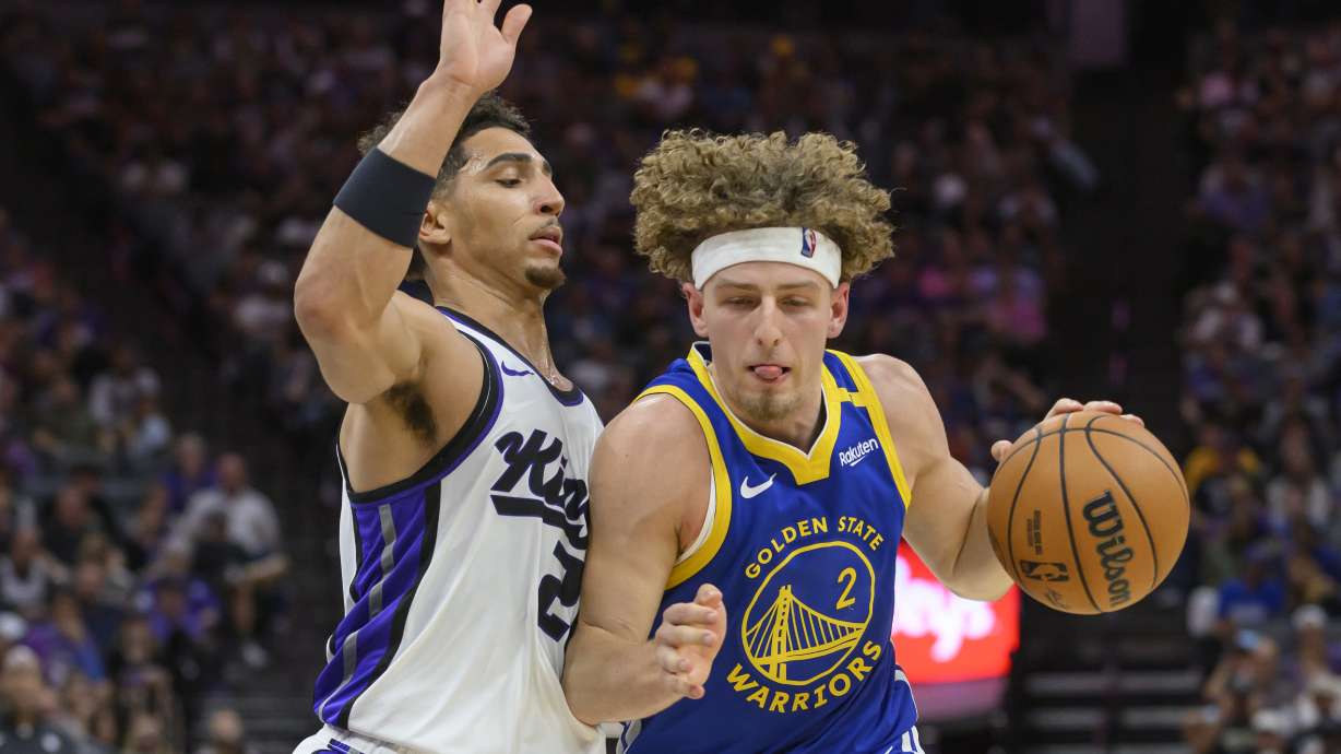 Golden State Warriors guard Brandin Podziemski (2) is guarded by Sacramento Kings guard Colby Jones (20) during the second half of a preseason NBA basketball game in Sacramento, Calif., Wednesday, Oct. 9, 2024.