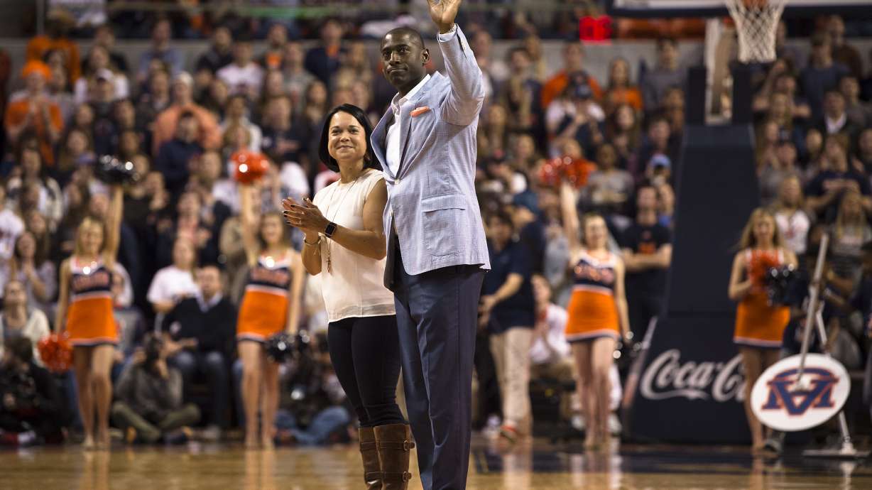 FILE - Allen Greene, Auburn Athletic Director, waives as his wife, Christy, and he are introduced during the first half of an NCAA college basketball game, Jan. 20, 2018, in Auburn, Ala.