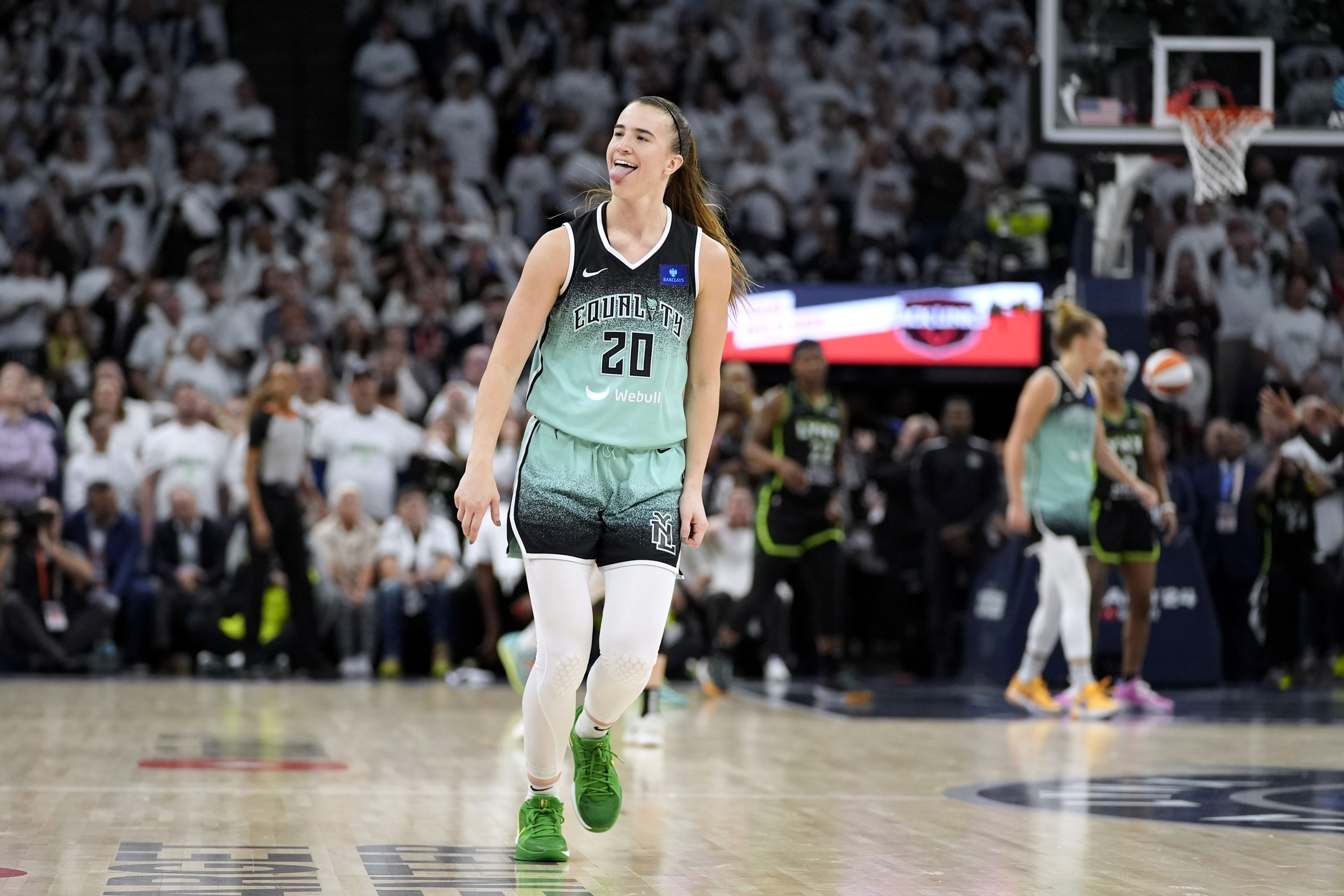 New York Liberty guard Sabrina Ionescu celebrates after making a 3-point basket at the end of Game 3 of a WNBA basketball final playoff series against the Minnesota Lynx, Wednesday, Oct. 16, 2024, in Minneapolis. The Liberty won 80-77.