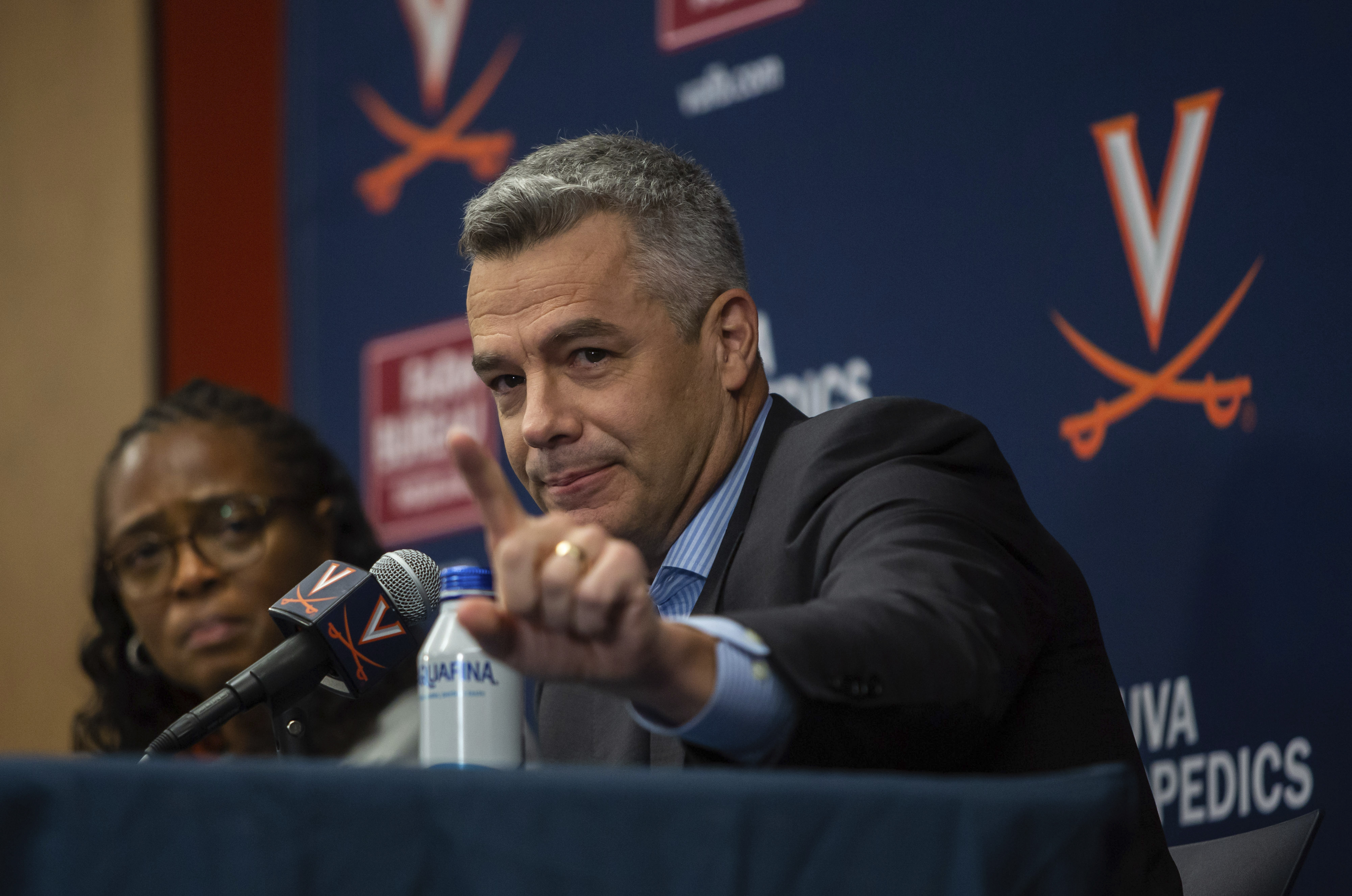 Virginia NCAA college basketball coach Tony Bennett announces his retirement as athletic director Carla Willliams looks on during a press conference in Charlottesville, Va., Friday, Oct. 18, 2024.