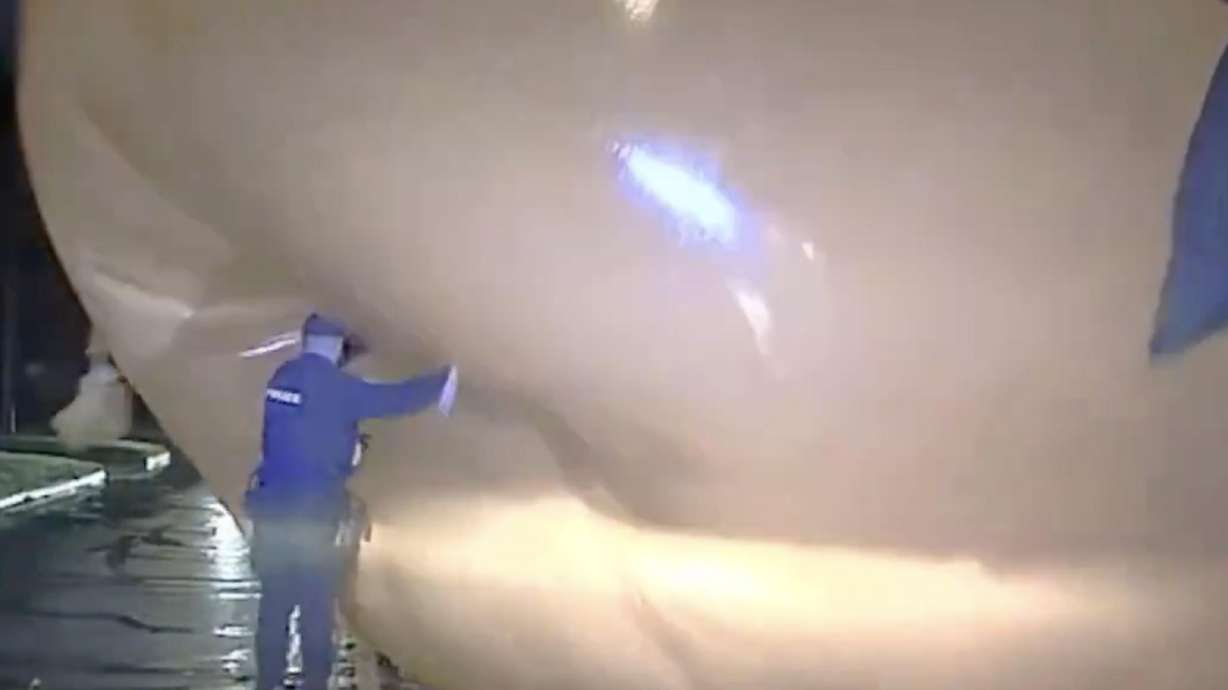 Dashcam footage shows a police officer in Ohio being consumed by a renegade inflated pumpkin.