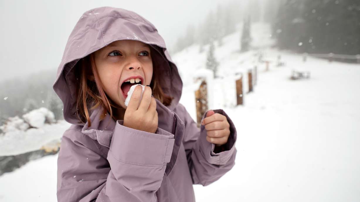 Haddie McGough, 8, eats snow at the Guardsman Pass Overlook during a snowstorm on Oct. 17. Last month was Utah's warmest October on record, but many places started the water year off strongly because of the month's stormy second half.