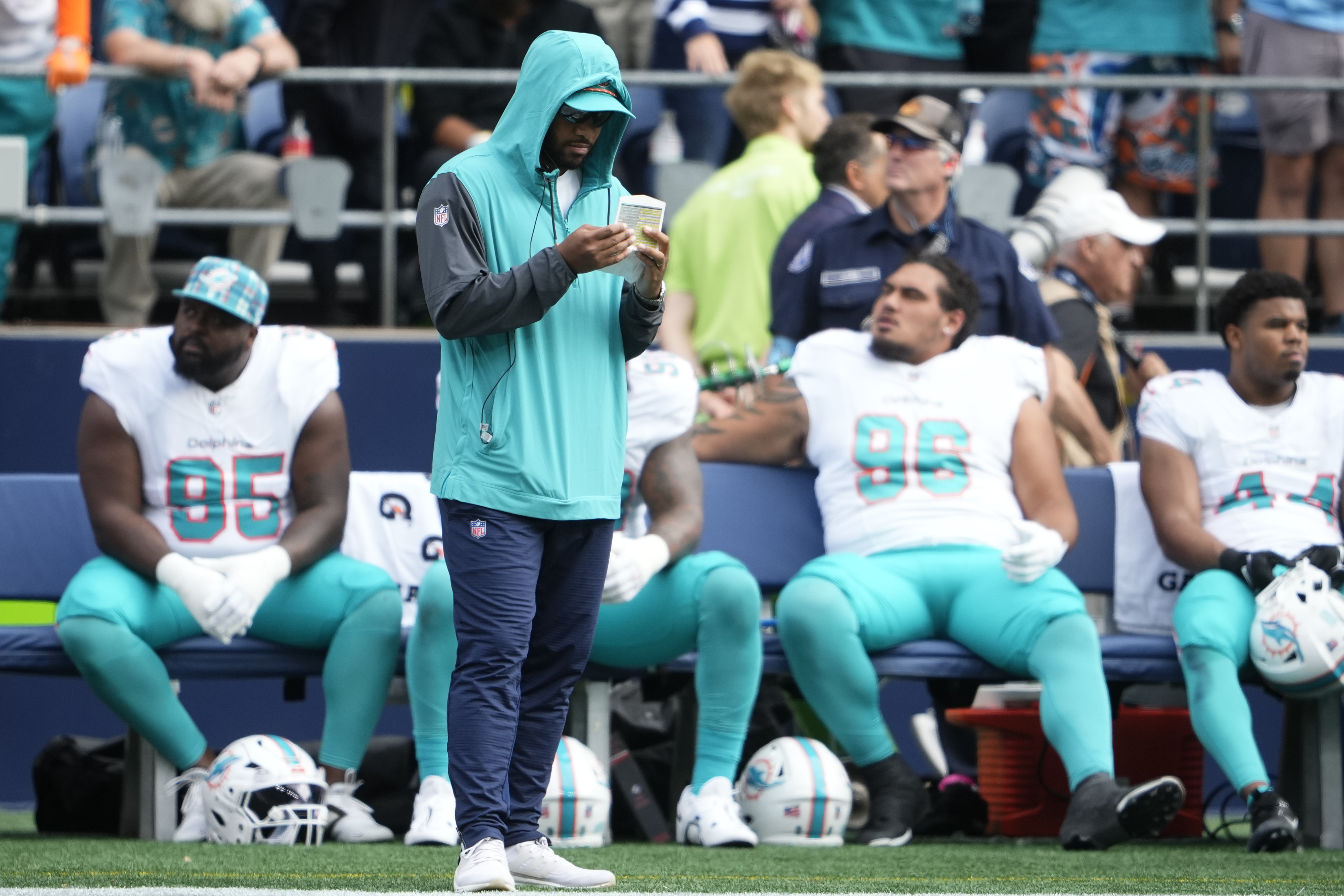 Miami Dolphins quarterback Tua Tagovailoa stands on the sideline during the first half of an NFL football game against the Seattle Seahawks, Sunday, Sept. 22, 2024, in Seattle. 