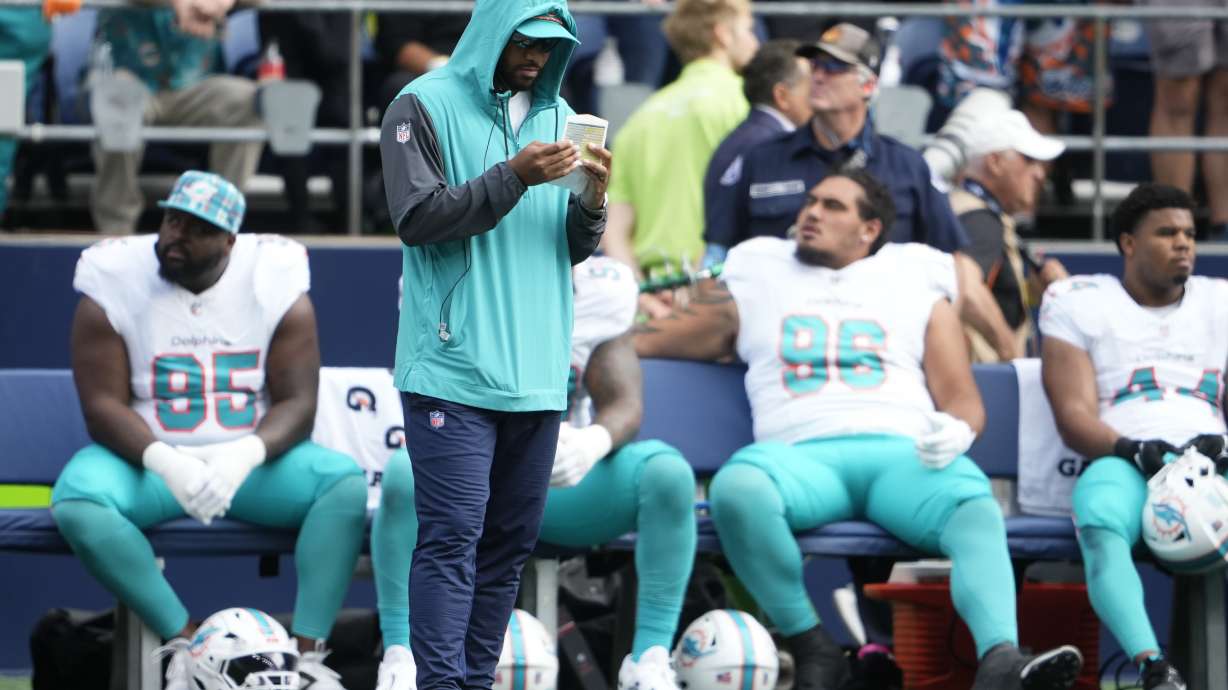 Miami Dolphins quarterback Tua Tagovailoa stands on the sideline during the first half of an NFL football game against the Seattle Seahawks, Sunday, Sept. 22, 2024, in Seattle.
