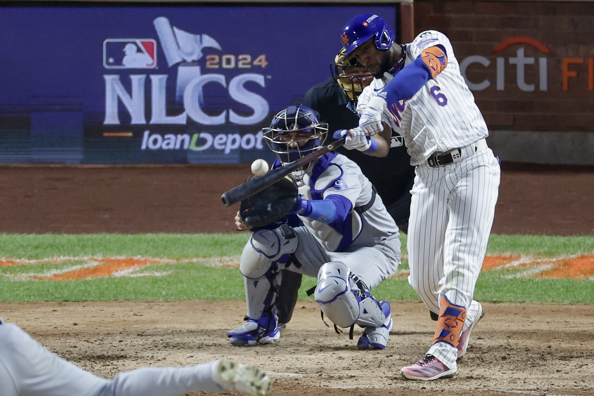 New York Mets' Starling Marte hits a RBI-single against the Los Angeles Dodgers during the eighth inning in Game 5 of a baseball NL Championship Series, Friday, Oct. 18, 2024, in New York. 