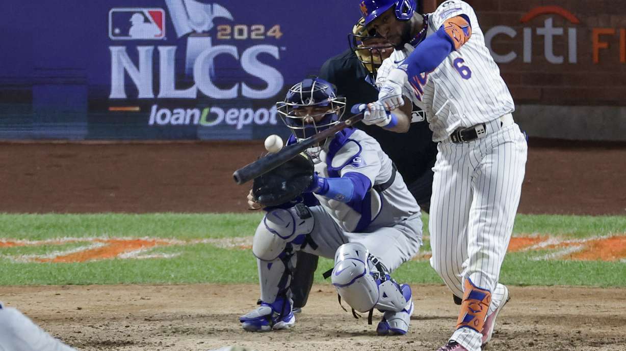 New York Mets' Starling Marte hits a RBI-single against the Los Angeles Dodgers during the eighth inning in Game 5 of a baseball NL Championship Series, Friday, Oct. 18, 2024, in New York.