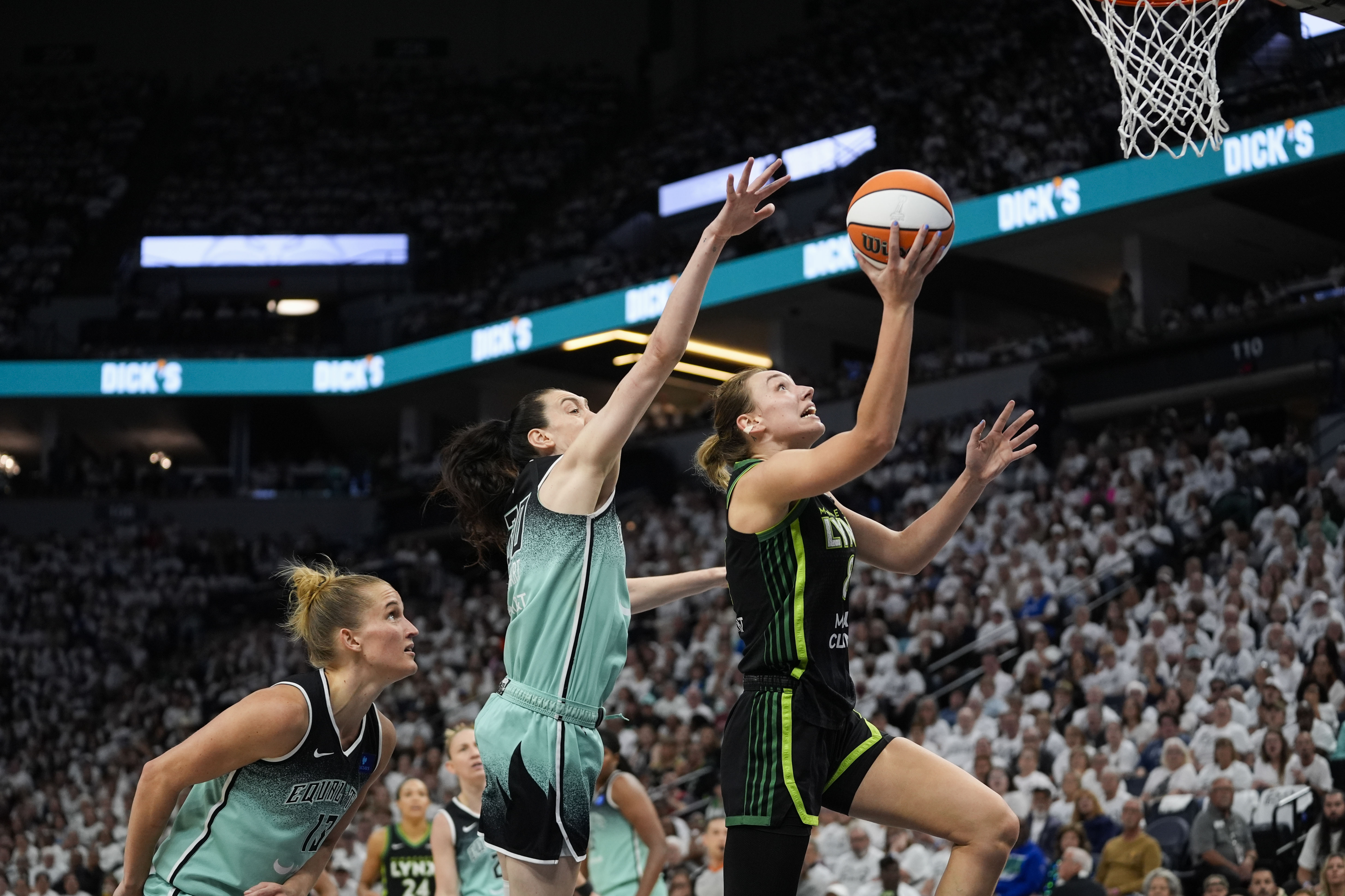 Minnesota Lynx forward Alanna Smith (8) drives to the basket against New York Liberty forward Breanna Stewart during the second half of Game 4 of a WNBA basketball final playoff series, Friday, Oct. 18, 2024, in Minneapolis. 