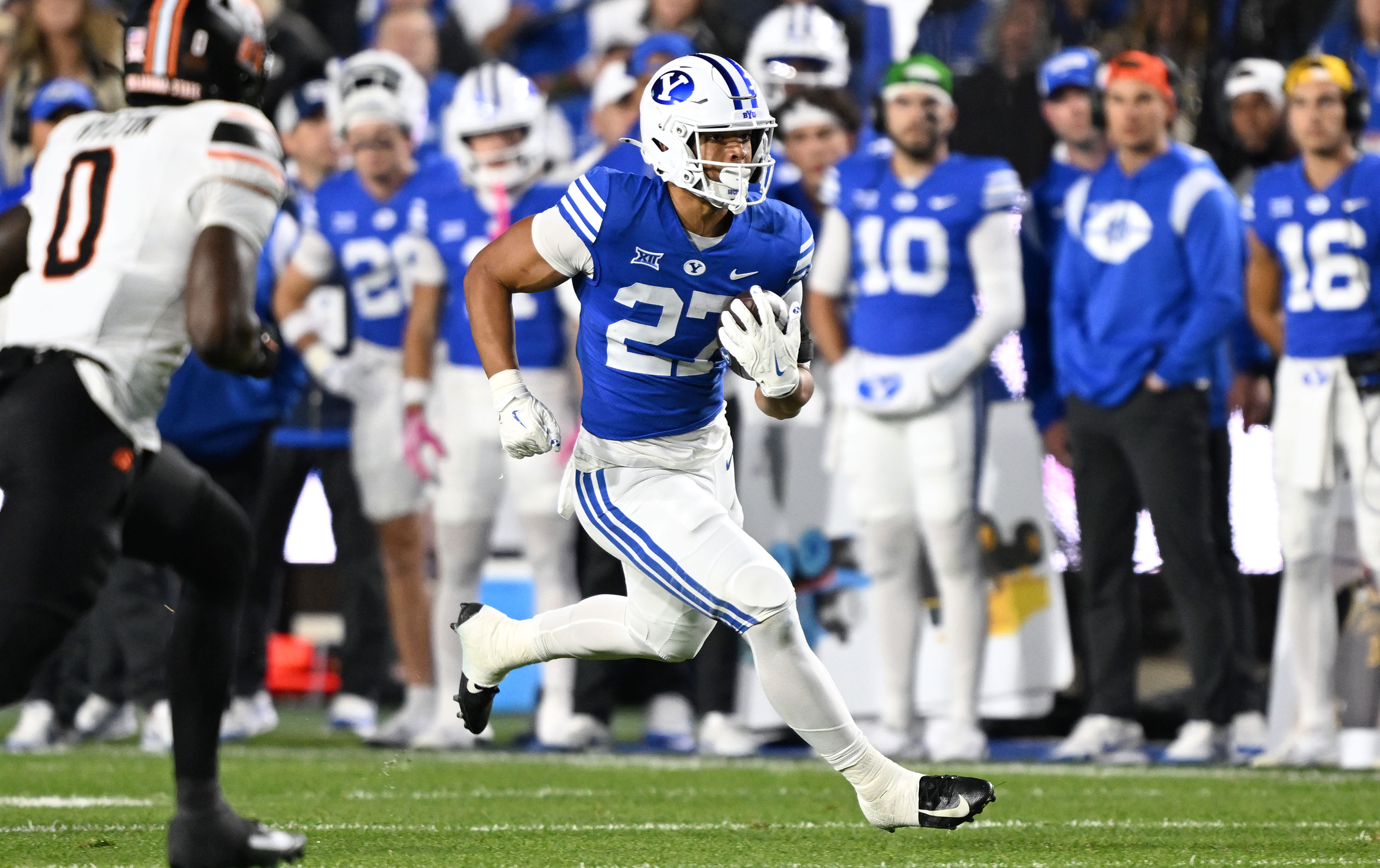 Brigham Young running back LJ Martin (27) away into the secondary as BYU and Oklahoma State play in Provo at LaVell Edwards Stadium on Friday Oct. 16, 2024.