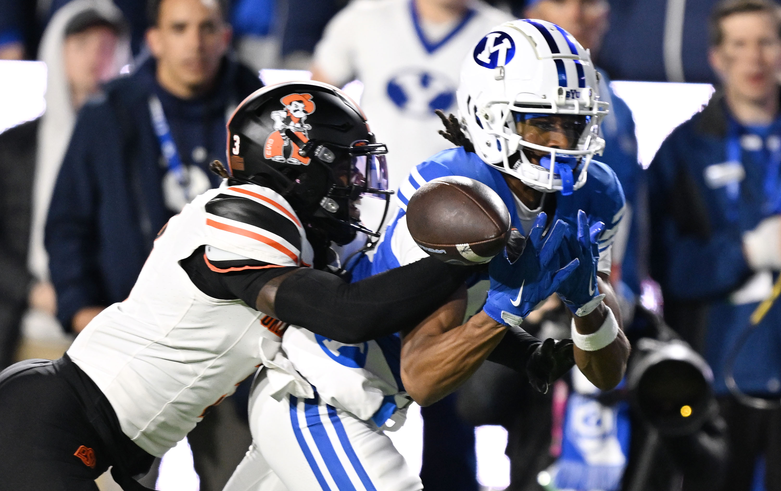 Oklahoma State cornerback Cam Smith (3) dislodges the ball from BYU wide receiver Jojo Phillips (13) as BYU and Oklahoma State play at LaVell Edwards Stadium in Provo on Friday, Oct. 18, 2024.