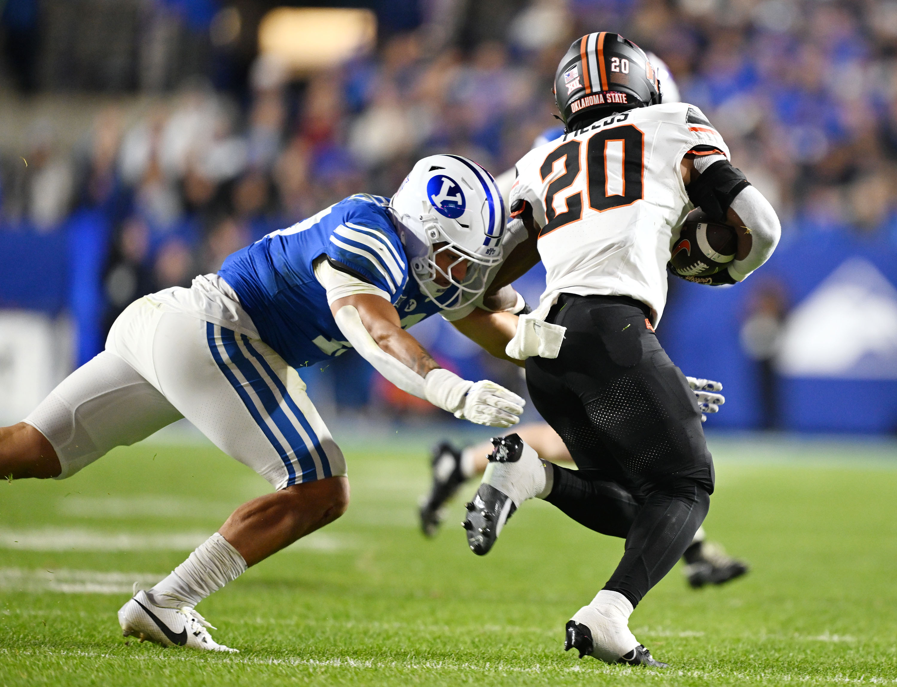 Brigham Young linebacker Jack Kelly (17) tries to hit Oklahoma State Cowboys running back Rodney Fields Jr. (20) as BYU and Oklahoma State play in Provo at LaVell Edwards Stadium on Friday Oct. 16, 2024.