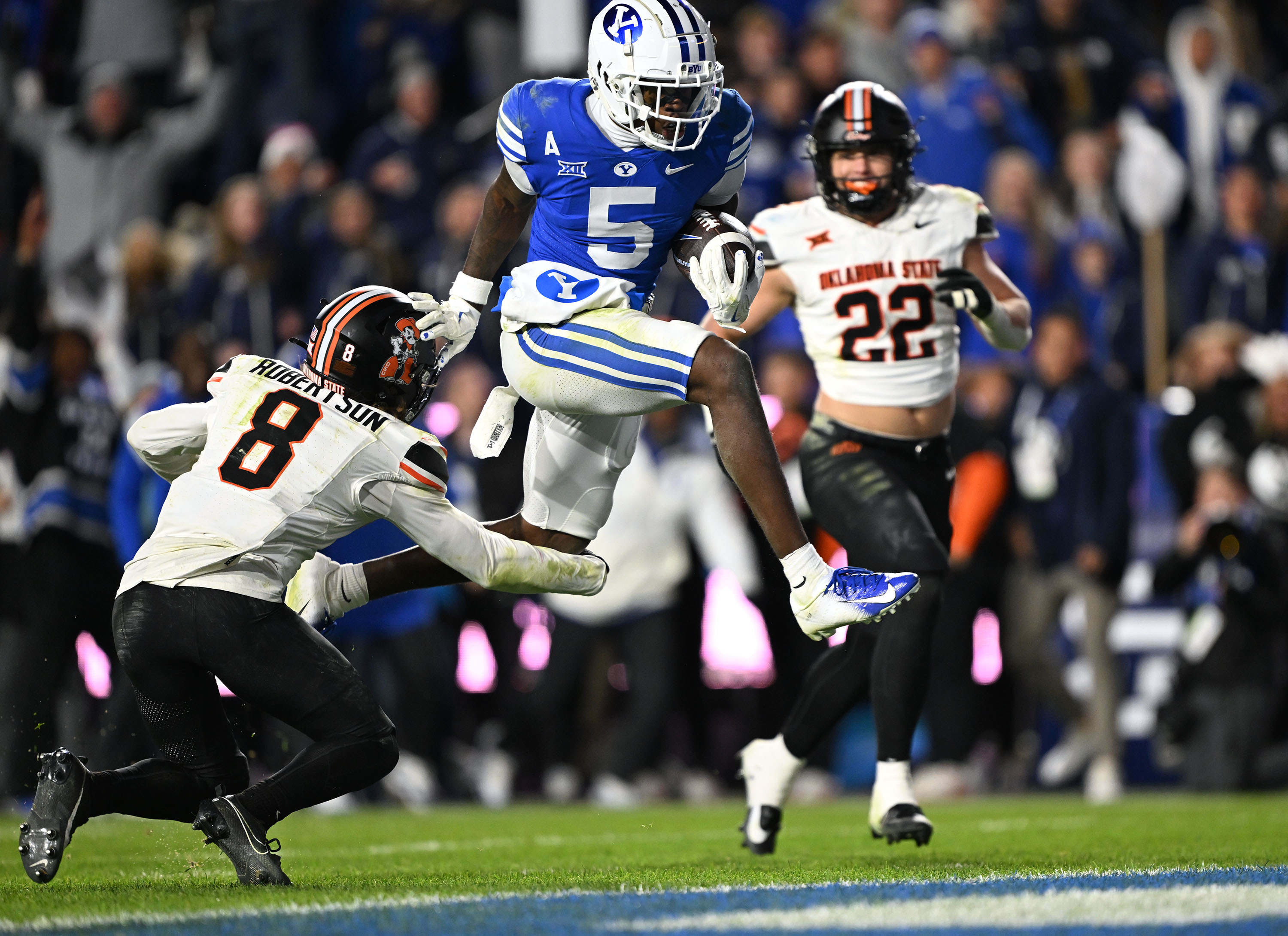 Brigham Young wide receiver Darius Lassiter (5) jumps into the end zone giving the Cougars the lead as BYU and Oklahoma State play in Provo at LaVell Edwards Stadium on Friday Oct. 18, 2024. BYU won 38-35.