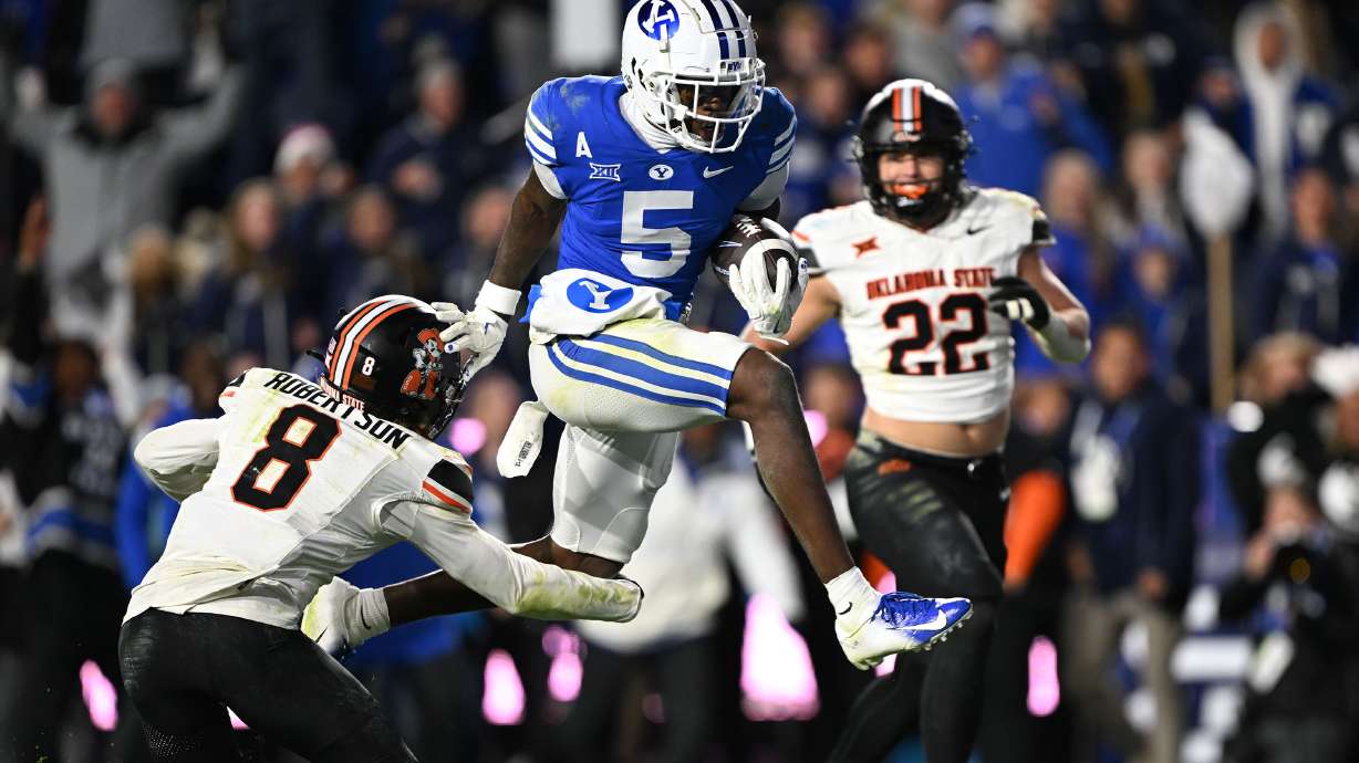 Brigham Young wide receiver Darius Lassiter (5) jumps into the end zone giving the Cougars the lead as BYU and Oklahoma State play in Provo at LaVell Edwards Stadium on Friday Oct. 18, 2024. BYU won 38-35.