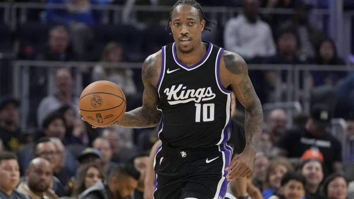 Sacramento Kings forward DeMar DeRozan (10) brings the ball up the court against the Golden State Warriors during the first half of an NBA preseason basketball game in San Francisco, Friday, Oct. 11, 2024.