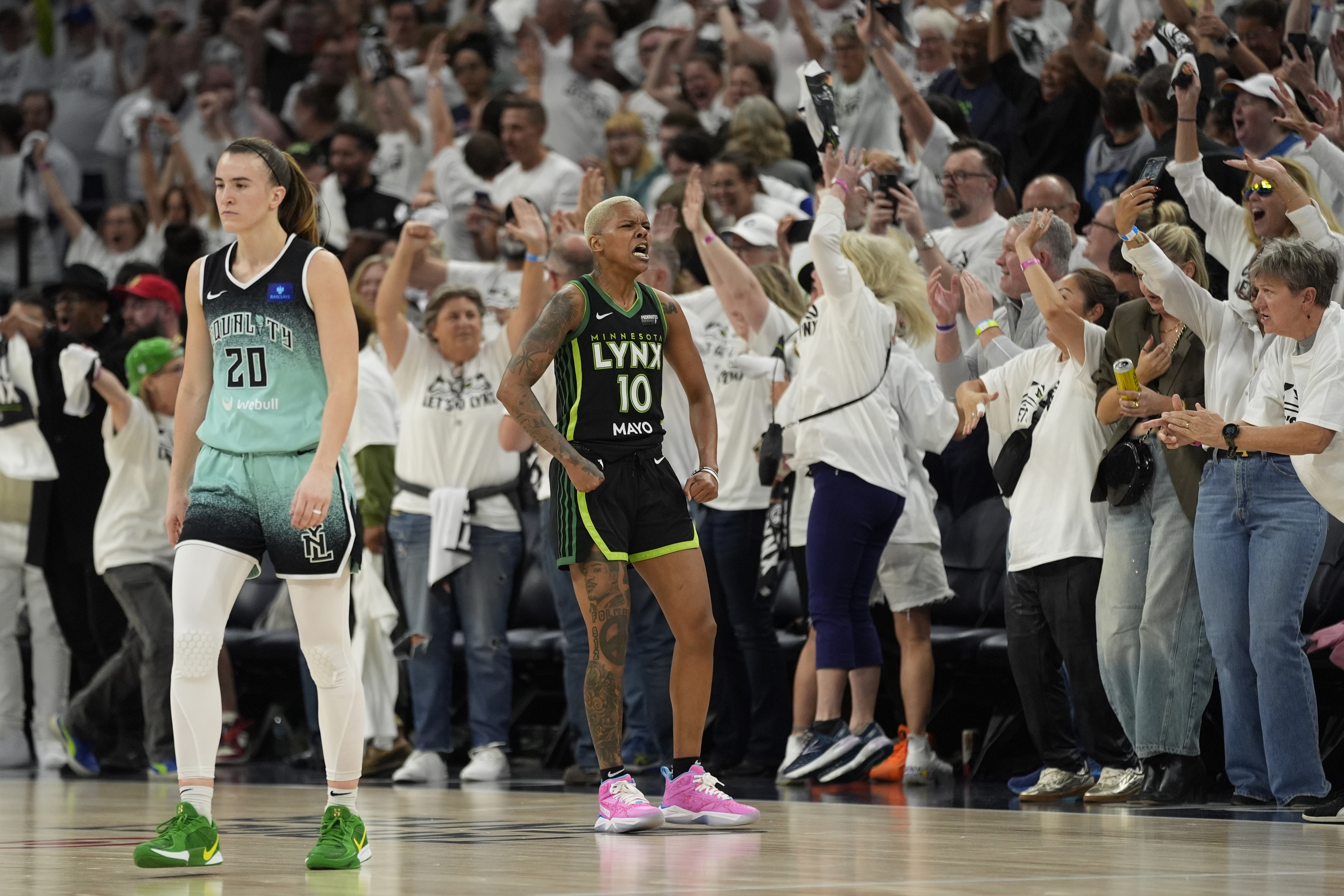 Minnesota Lynx guard Courtney Williams (10) celebrates after a missed shot by New York Liberty guard Sabrina Ionescu (20) at the buzzer during the second half of Game 4 of a WNBA basketball final playoff series, Friday, Oct. 18, 2024, in Minneapolis. The Lynx won 82-80, forcing a Game 5 in the series.