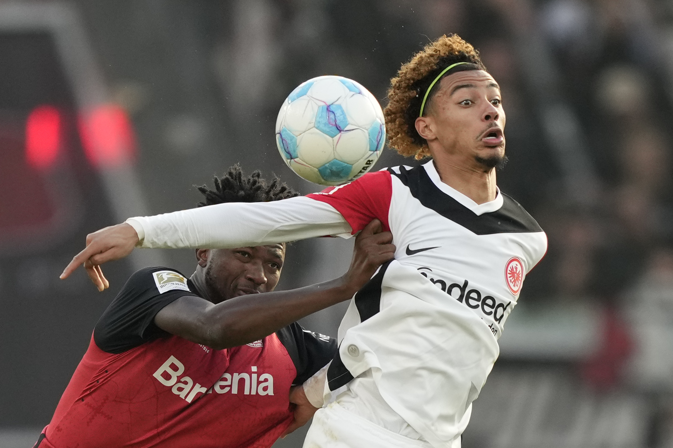Frankfurt's Hugo Ekitike, right, is challenged by Leverkusen's Edmond Tapsoba during the German Bundesliga soccer match between Bayer Leverkusen and Eintracht Frankfurt at the BayArena in Leverkusen, Germany, Saturday, Oct. 19, 2024. 