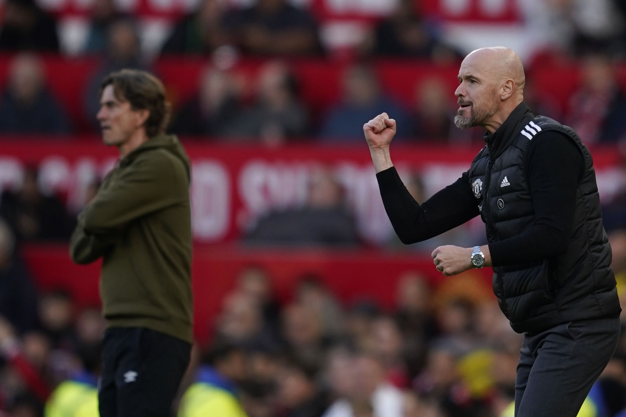 Manchester United's head coach Erik ten Hag, right, and Brentford's head coach Thomas Frank react during the English Premier League soccer match between Manchester United and Brentford at Old Trafford stadium in Manchester, England, Saturday, Oct. 19, 2024. 