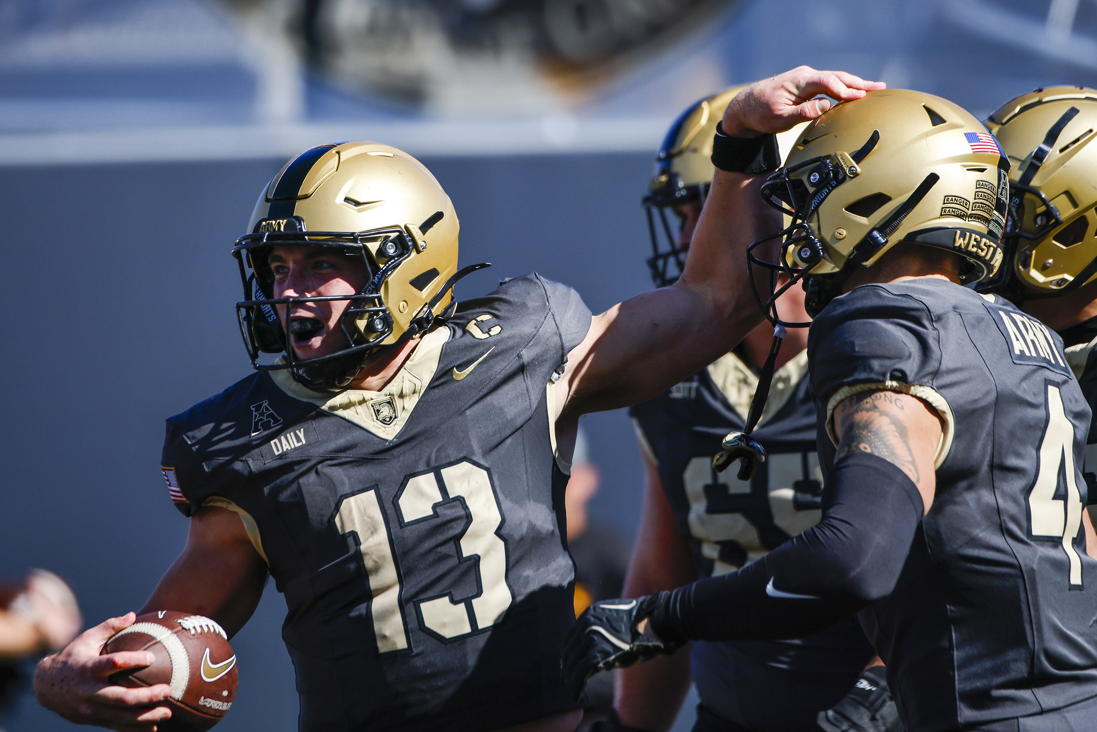 Army quarterback Bryson Daily, left, celebrates a touchdown during an NCAA college football game against East Carolina, Saturday, Oct. 19, 2024, in West Point, N.Y. 