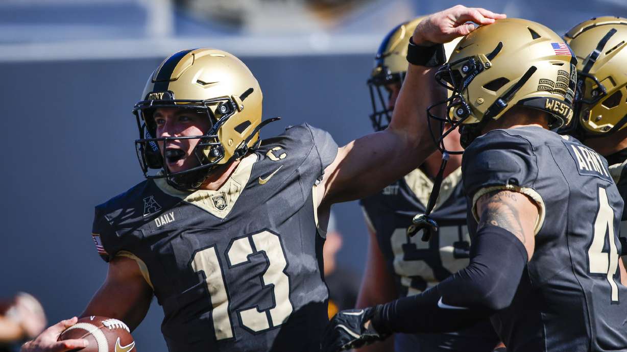 Army quarterback Bryson Daily, left, celebrates a touchdown during an NCAA college football game against East Carolina, Saturday, Oct. 19, 2024, in West Point, N.Y.