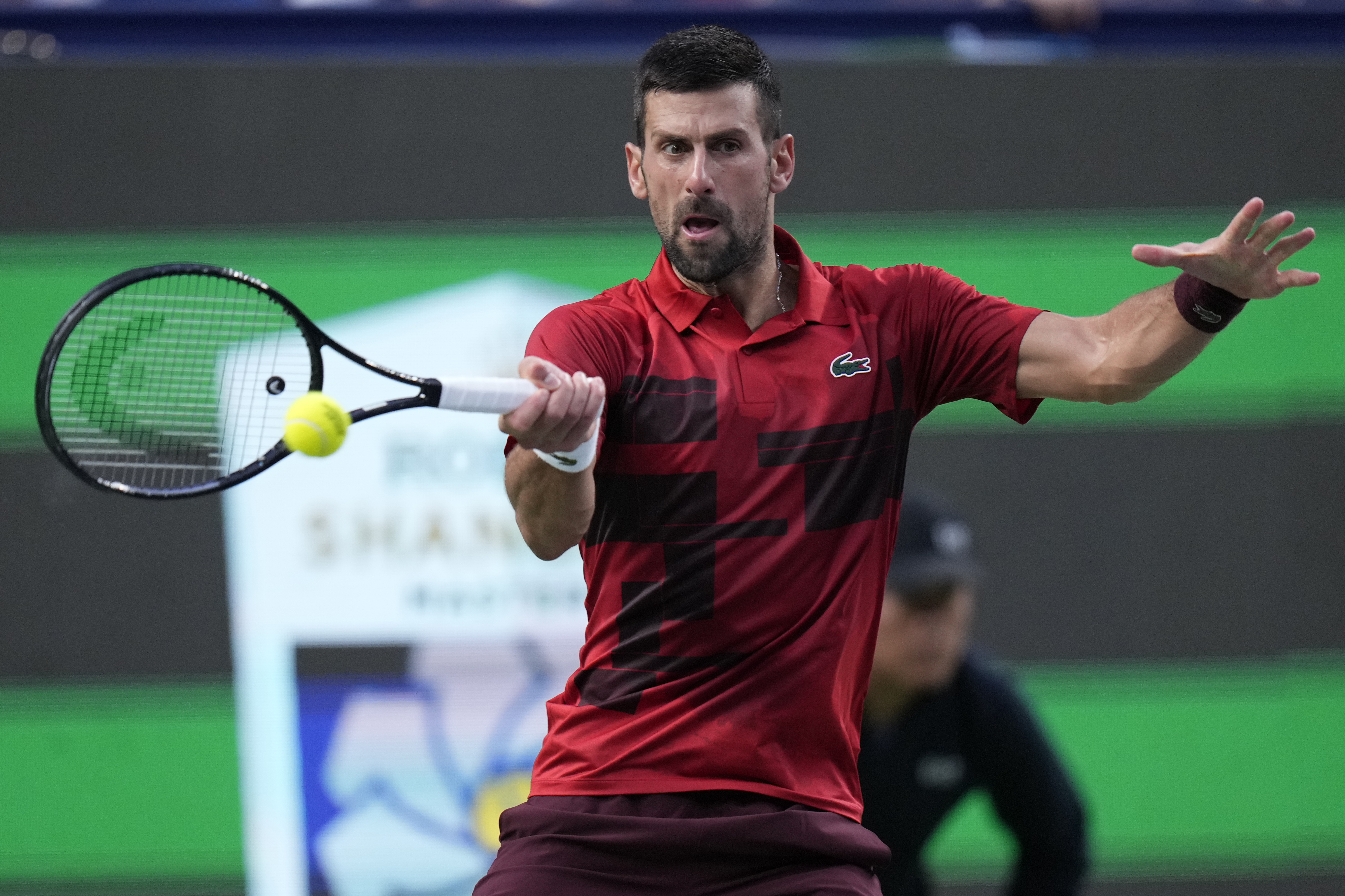 Novak Djokovic of Serbia returns a shot against Jannik Sinner of Italy during the men's singles finals match in the Shanghai Masters tennis tournament at Qizhong Forest Sports City Tennis Center in Shanghai, China, Sunday, Oct. 13, 2024.