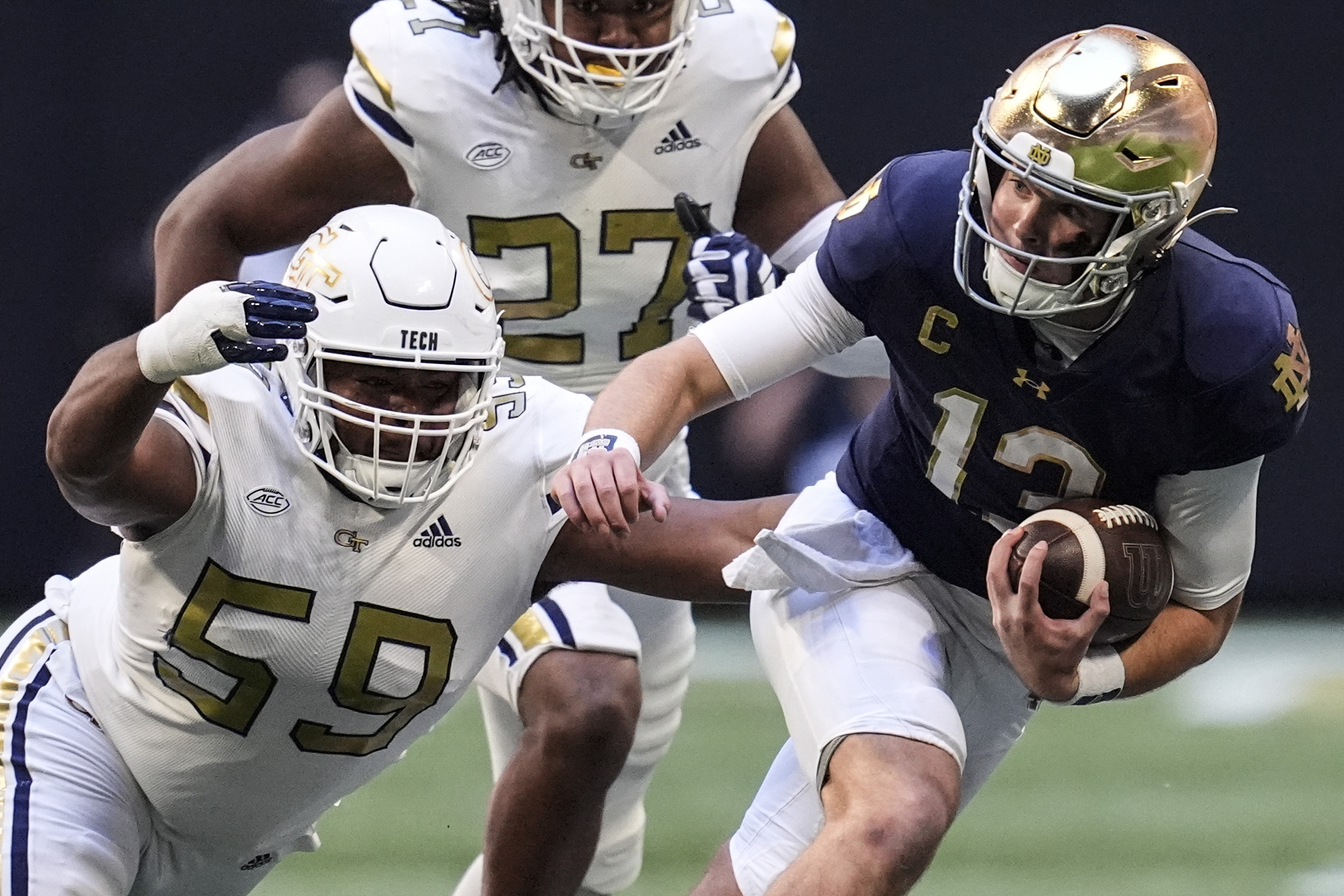 Notre Dame quarterback Riley Leonard (13) runs against Georgia Tech defensive lineman Thomas Gore (59) during the first half of an NCAA college football game, Saturday, Oct. 19, 2024, in Atlanta. 