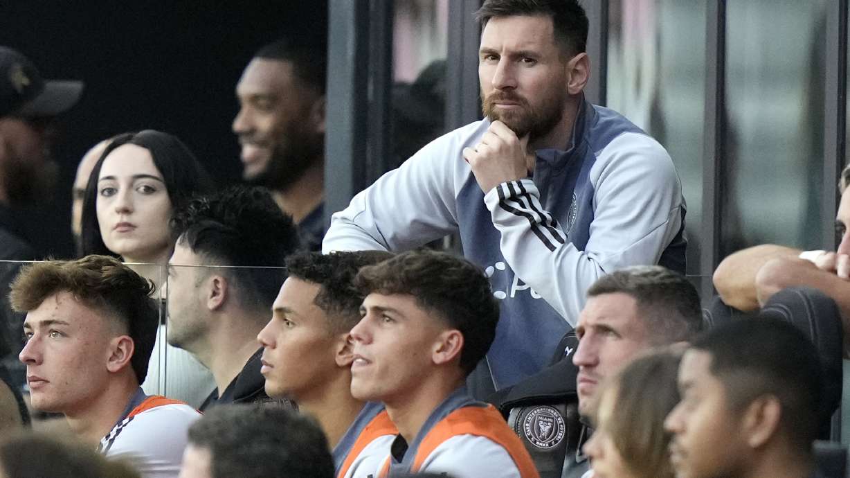 Inter Miami forward Lionel Messi watches from the bench during the first half of an MLS soccer match against the New England Revolution, Saturday, Oct. 19, 2024, in Fort Lauderdale, Fla.