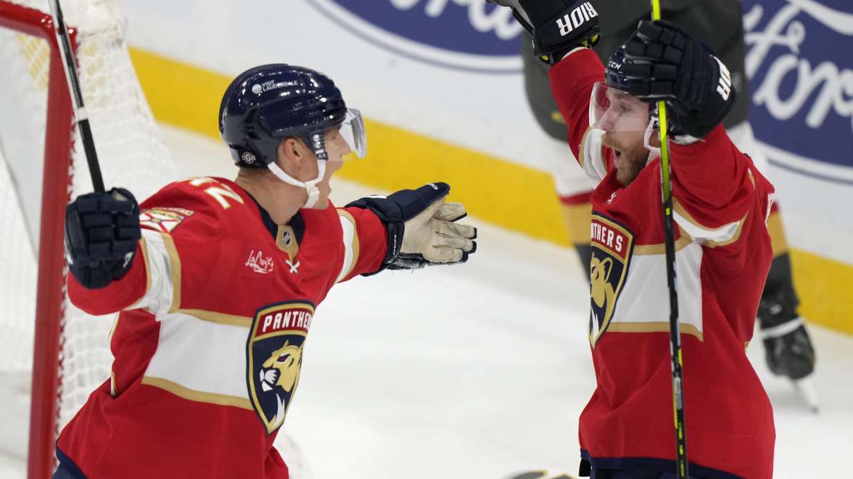 Florida Panthers defenseman Gustav Forsling, left, celebrates with center Sam Bennett after Forsling scored during an overtime period of an NHL hockey game, Saturday, Oct. 19, 2024, in Sunrise, Fla.