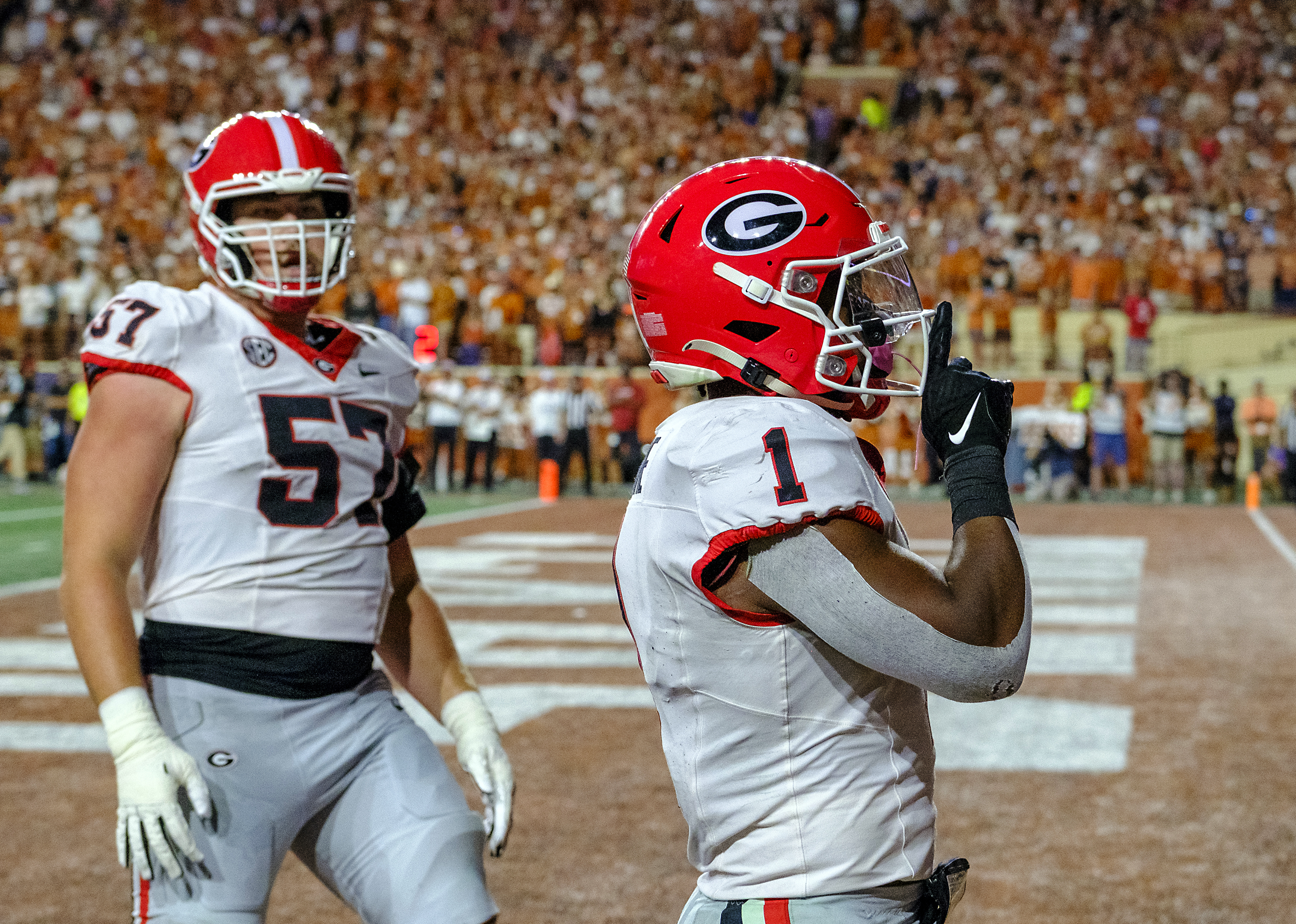 Georgia running back Trevor Etienne (1) celebrates his touchdown run against Texas as Georgia offensive lineman Monroe Freeling (57) looks on during the first half of an NCAA college football game in Austin, Texas, Saturday, Oct. 19, 2024.